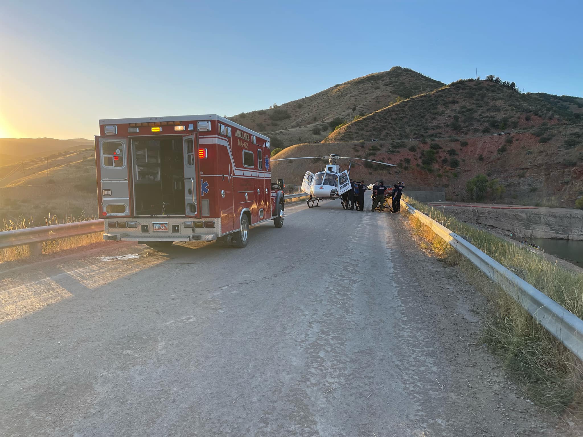 Paramedics transport a man who may have broken his back while cliff diving at Causey Reservoir, according to the Weber County Sheriff's Office. 