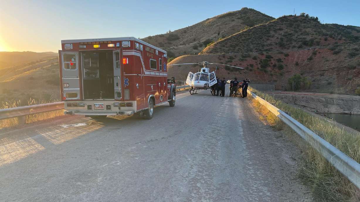 Paramedics transport a man who may have broken his back while cliff diving at Causey Reservoir, according to the Weber County Sheriff's Office.