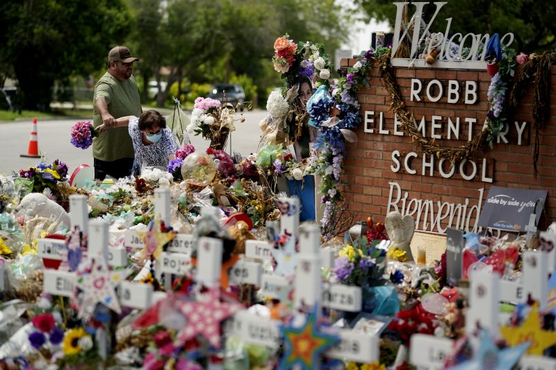 Retired teachers Raul Noyola and Ofelia Noyola visit a memorial honoring the school shooting victims at Robb Elementary on July 12 in Uvalde, Texas.