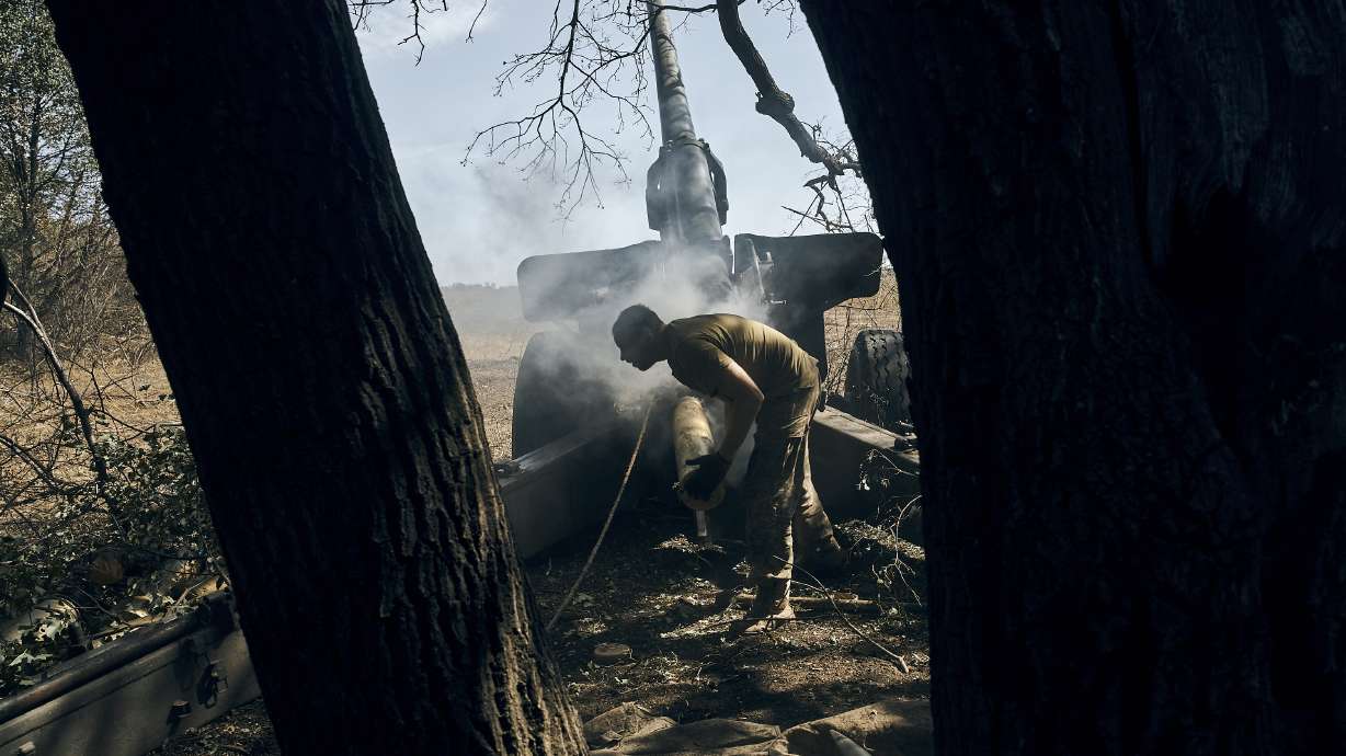 A Ukrainian soldier fires on the front line in the Donetsk region, eastern Ukraine, Saturday.