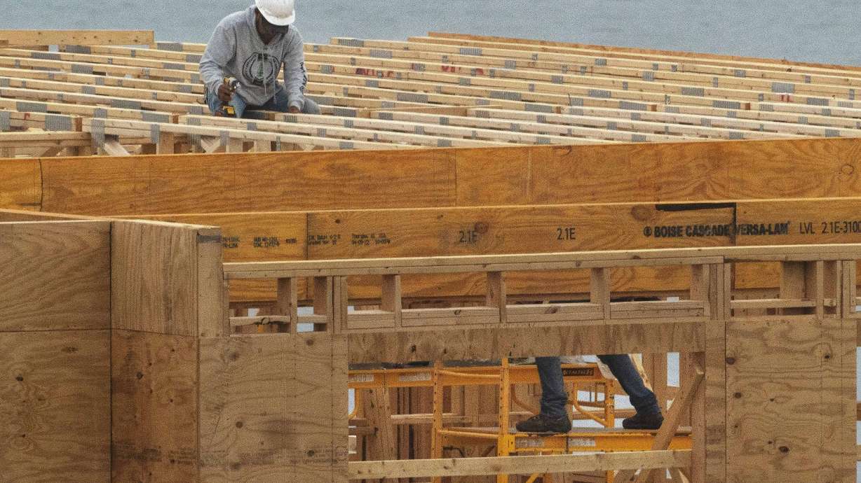 Builders work on a four-story, 45-unit condominium building under construction on May 31, in Portland, Maine. The COVID-19 pandemic shook up the U.S. housing market and the nation's migration patterns as remote work gave Americans new levels of freedom to choose where they wanted to live.
