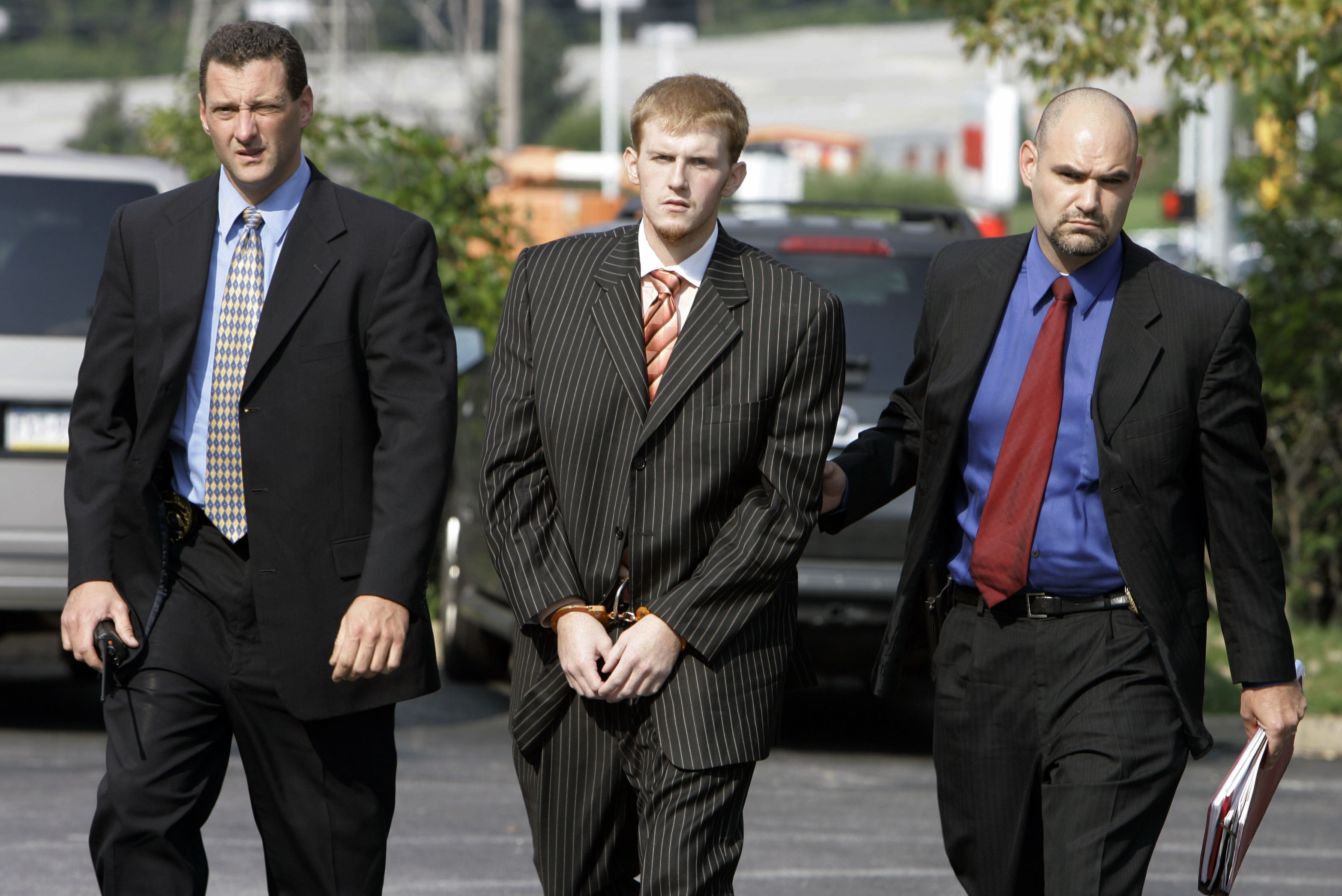 FILE - In this Aug. 29, 2007, file photo, Britt Reid is escorted into the Montgomery County district court house in Conshohocken, Pa. Former Kansas City Chiefs assistant coach Britt Reid is scheduled to enter a guilty plea to felony driving while intoxicated related to a car crash that seriously injured a young girl. Jackson County Circuit Court online records show Reid, the son of Chiefs coach Andy Reid, is scheduled to plead guilty on Monday, Sept. 12, 2022.  