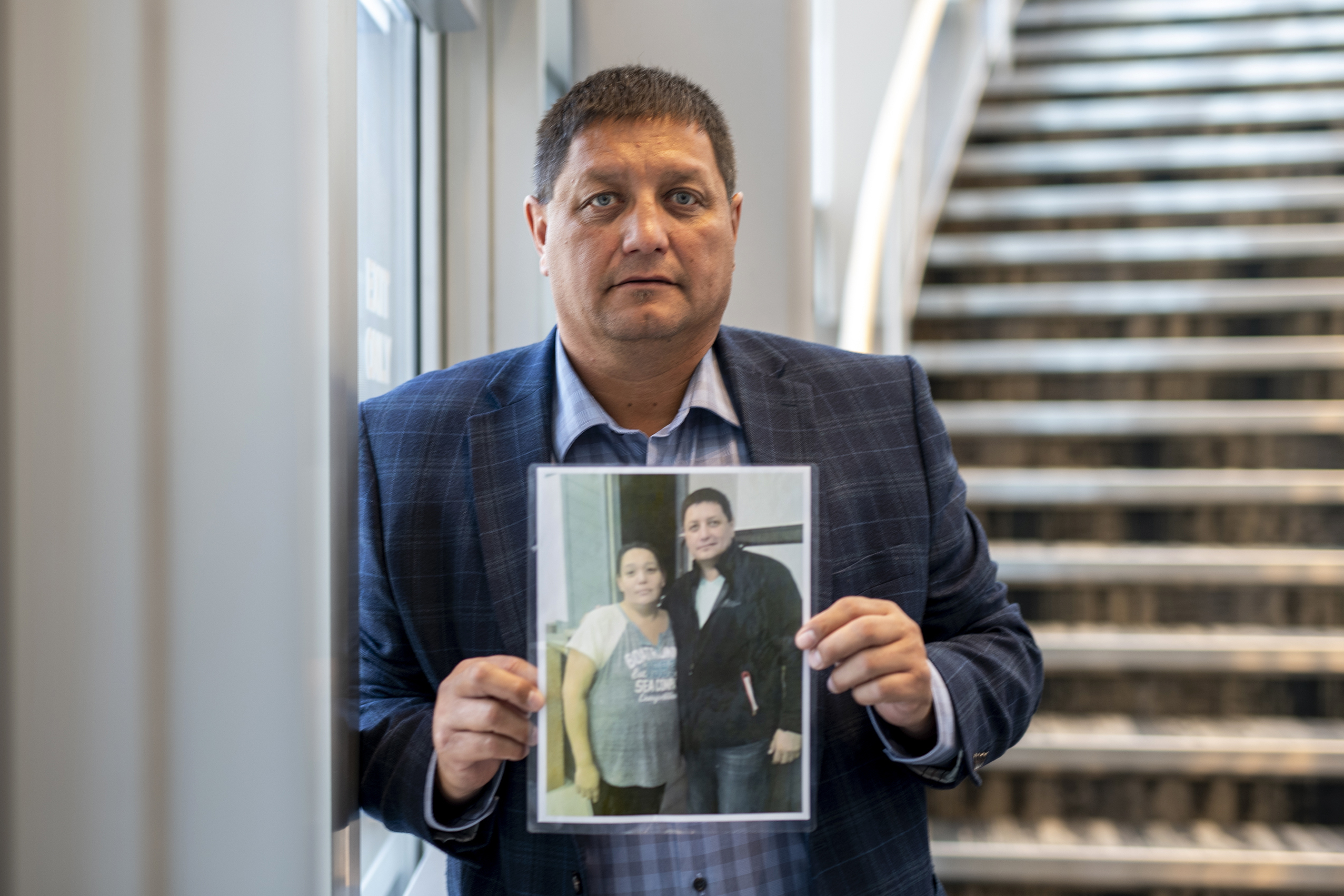 Mark Arcand, whose sister Bonnie Burns was killed during a series of violent attacks at James Smith Cree Nation, holds a photo in Saskatoon, Wednesday.