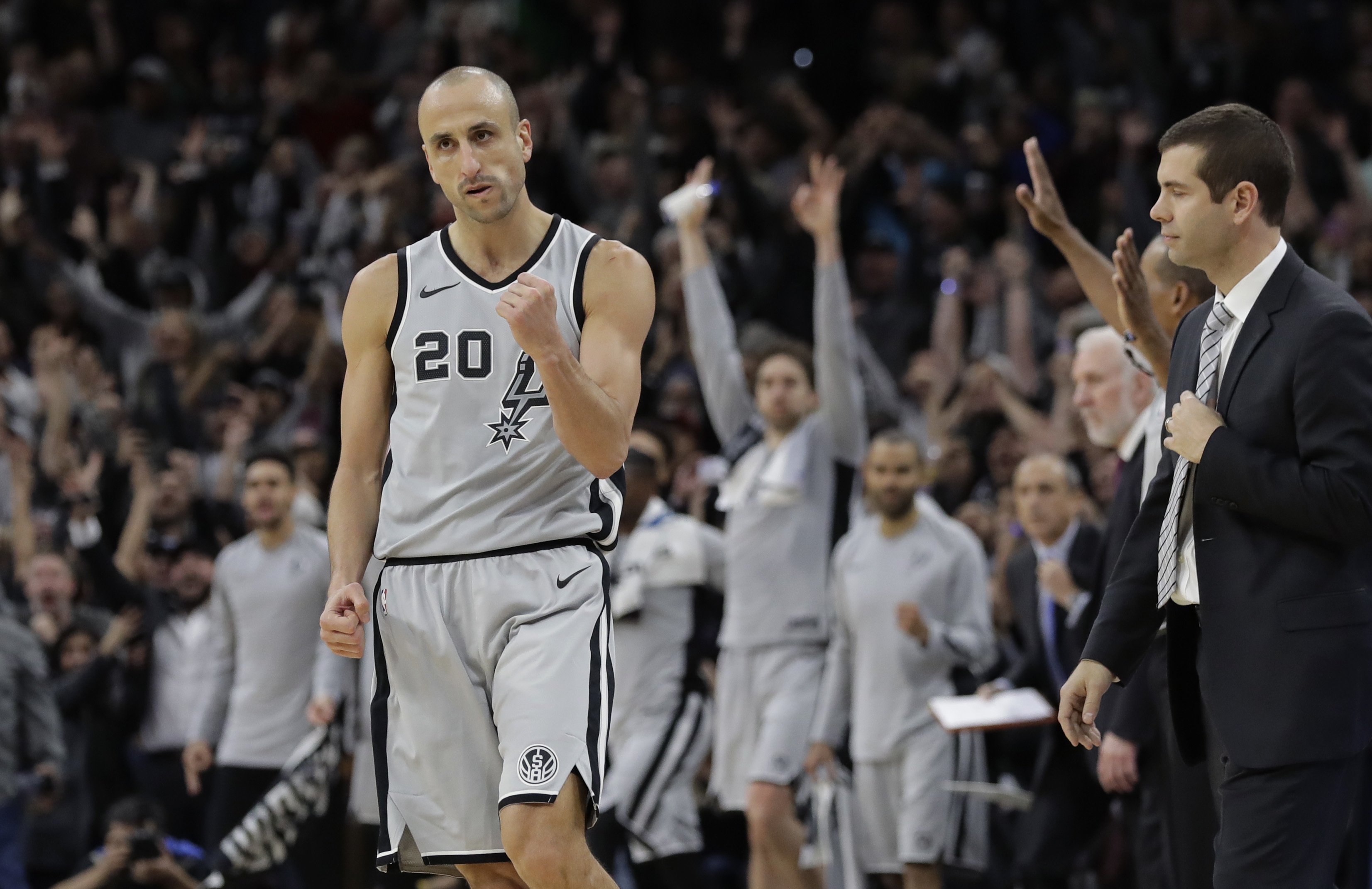 FILE - San Antonio Spurs guard Manu Ginobili (20) pumps his fist after hitting the winning shot in the final seconds of the team's NBA basketball game against the Boston Celtics, Friday, Dec. 8, 2017, in San Antonio. The four-time NBA champion with the San Antonio Spurs is one of the headliners for Saturday night’s enshrinement ceremony in Springfield, Massachusetts. 