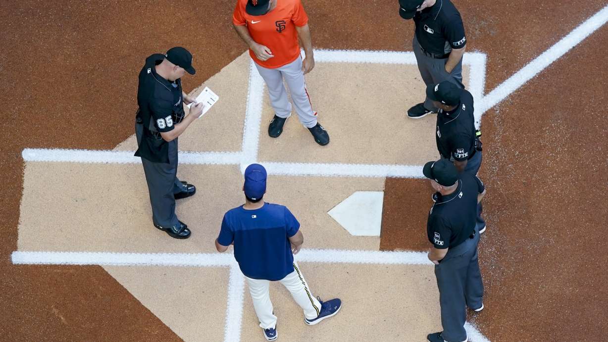San Francisco Giants' Scott Alexander and Milwaukee Brewers' Jason Alexander exchange lineups before game 2 of a doubleheader baseball game against the San Francisco Giants Thursday, Sept. 8, 2022, in Milwaukee.