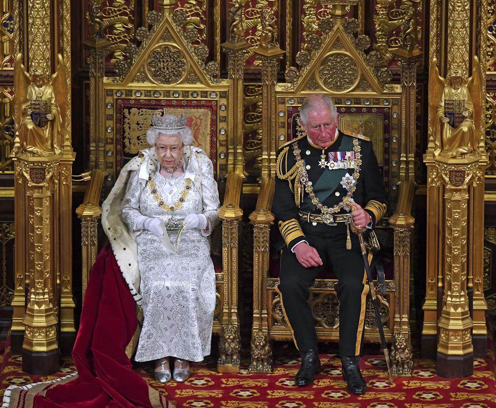 In this Oct. 14, 2019, photo, Britain's Queen Elizabeth II, with Prince Charles, delivers the Queen's Speech at the official State Opening of Parliament in London. Prince Charles has been preparing for the crown his entire life. Now, that moment has finally arrived.