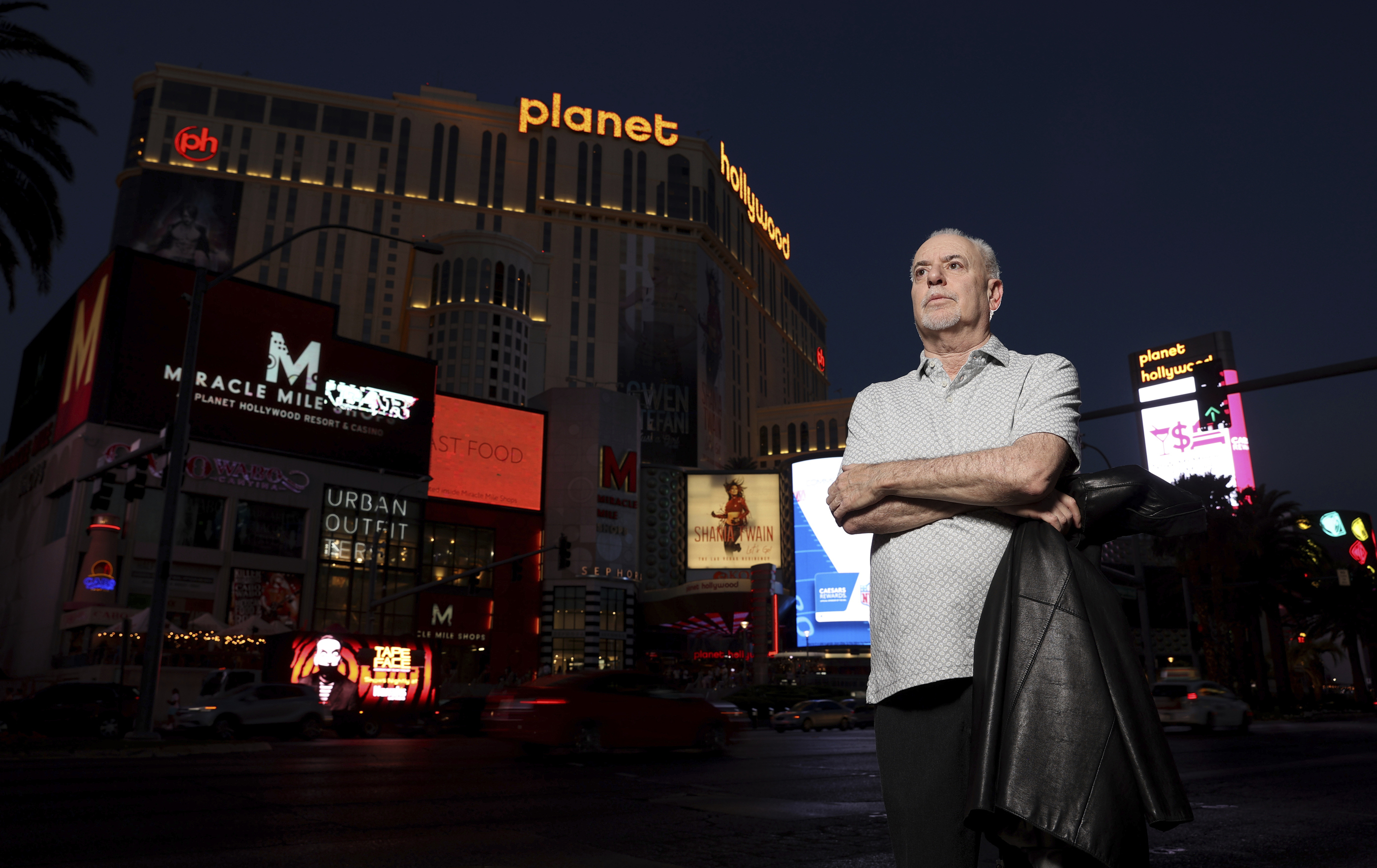 Jeff German, host of "Mobbed Up," poses with Planet Hollywood, formerly the Aladdin, in the background on the Strip in Las Vegas, June 2, 2021. Police say it was one of his latest targets, a county administrator, who fatally stabbed German last weekend. 
