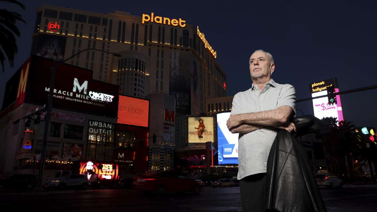 Jeff German, host of "Mobbed Up," poses with Planet Hollywood, formerly the Aladdin, in the background on the Strip in Las Vegas, June 2, 2021. Police say it was one of his latest targets, a county administrator, who fatally stabbed German last weekend.