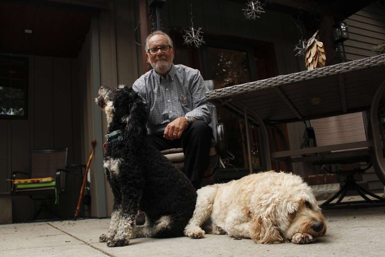 Gordon Haberman sits with his two dogs, Sept. 6, in West Bend, Wis. His daughter Andrea Haberman died in the Sept. 11, 2001, attacks in New York.