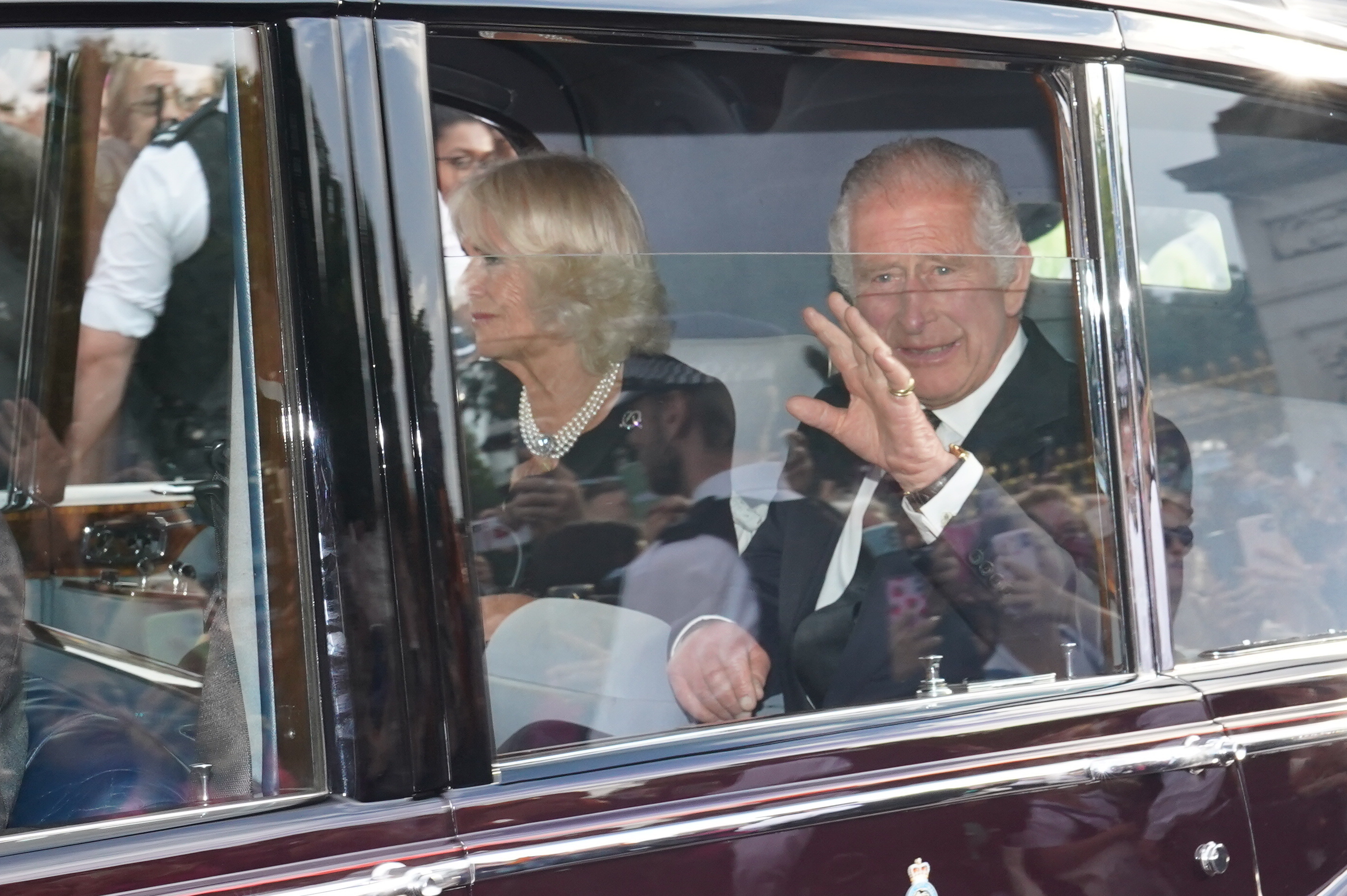 A car carrying Britain's King Charles III and Camilla, the Queen Consort, leaves Buckingham Palace following the death of Queen Elizabeth II on Thursday in London, Friday.