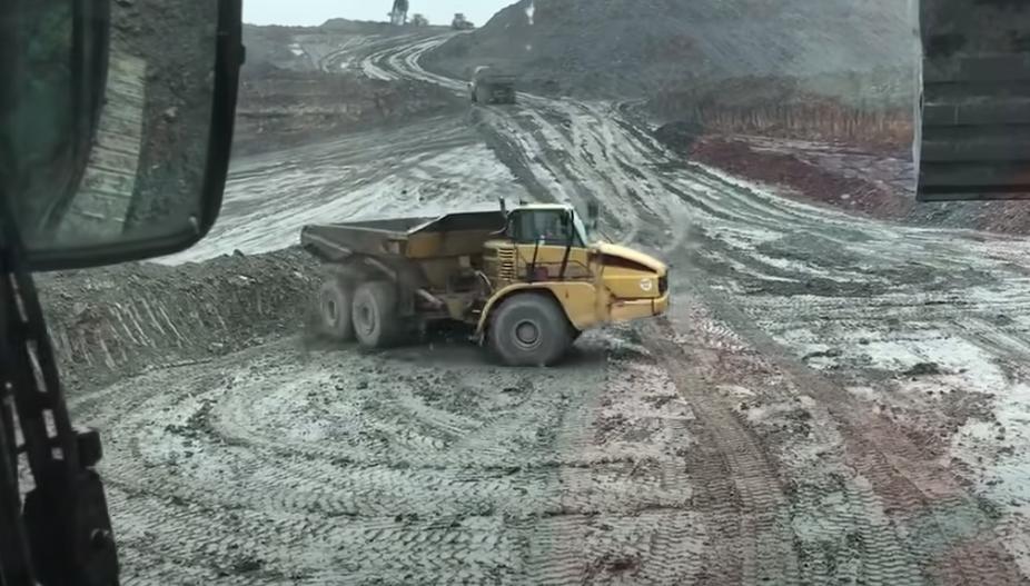 A dump truck driver in Chesterfield, England, positions his truck for hauling in March 2019.