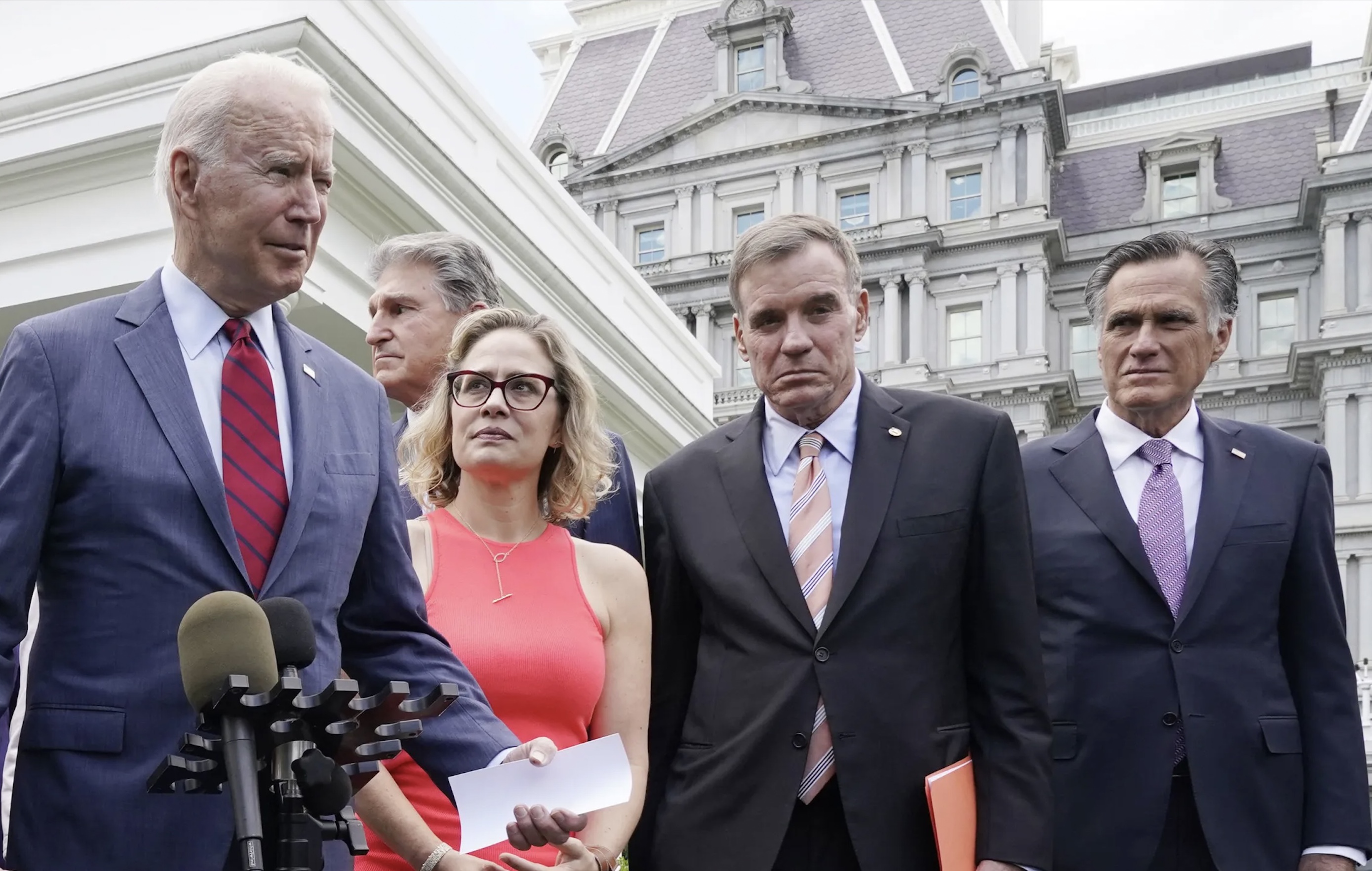President Joe Biden, with a bipartisan group of senators, speaks June 24, 2021, outside the White House in Washington. Biden invited a group of 21 Republican and Democratic senators including Sen. Mitt Romney, R-Utah, far right, for a visit on infrastructure. On the night in 2018 that Utah elected Romney to the U.S. Senate, Romney urged Biden to run for president, according to a new book.