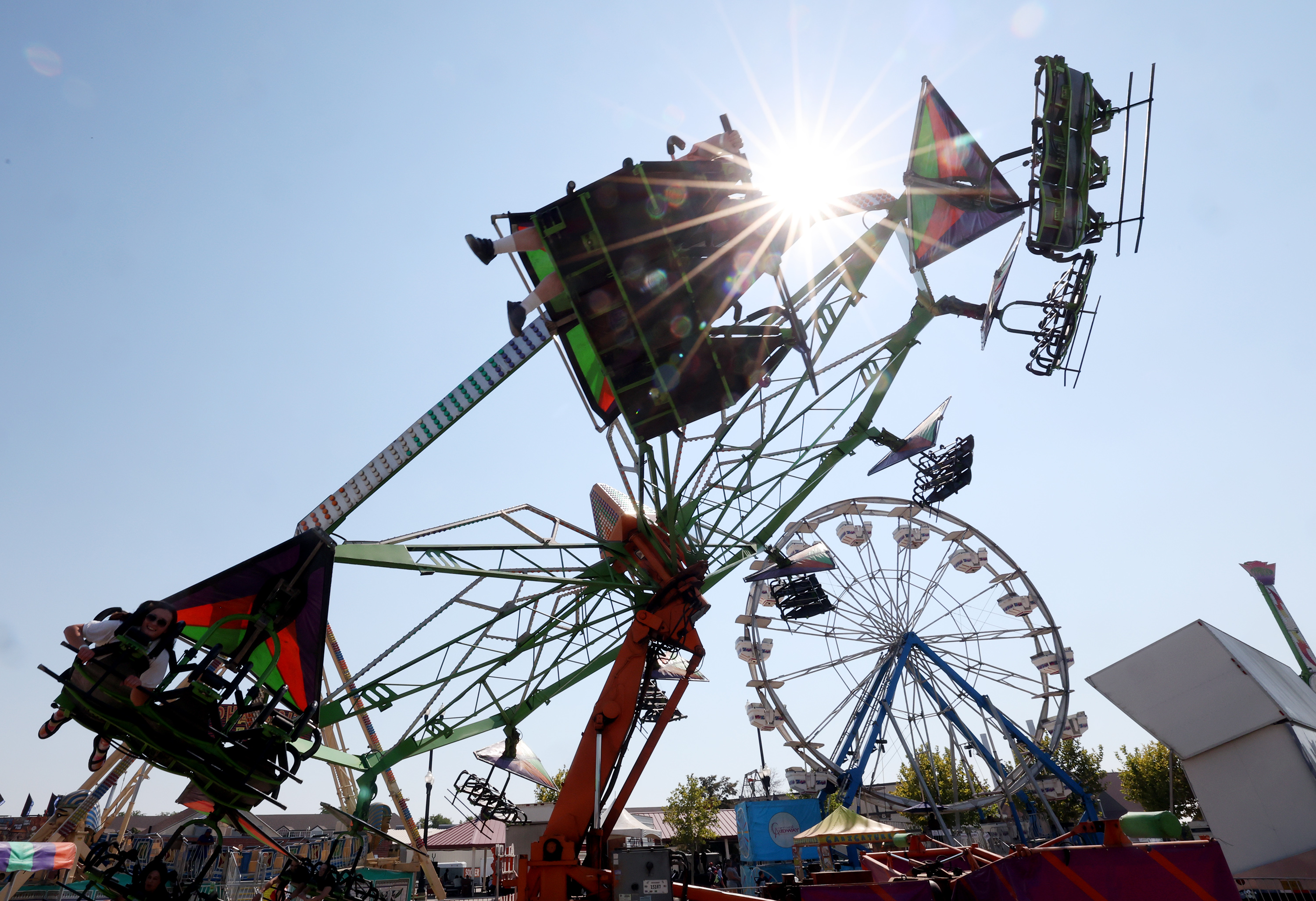 A few people enjoy a ride at the Utah State Fair in Salt Lake City on Friday.