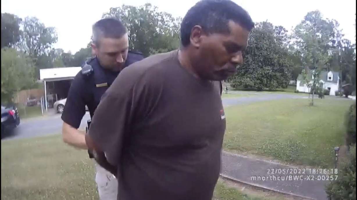 This image captured from bodycam video released by the Childersburg (Ala.) Police Department and provided by attorney Harry Daniels shows Michael Jennings, right, in custody in Childersburg, Ala., on May 22. Jennings was helping out a friend by watering flowers when officers showed up and placed him under arrest.