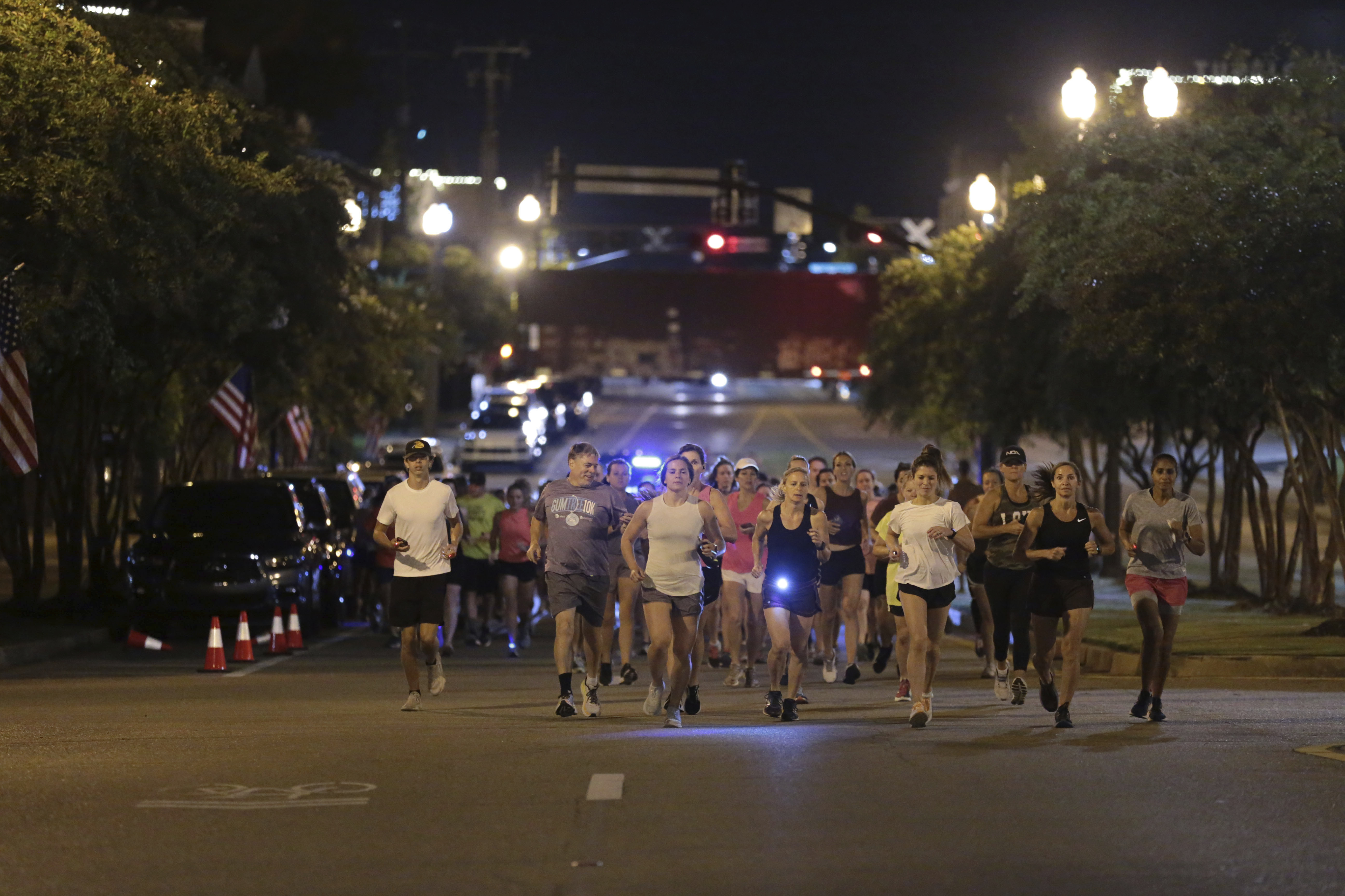 Runners make their way down Main Street in Tupelo, Miss. as they hold their "Liza's Lights" run early Friday morning, in Tupelo Miss., to remember Eliza Fletcher, who was abducted and murdered while she was running in the early morning hours in Memphis, Tenn. 