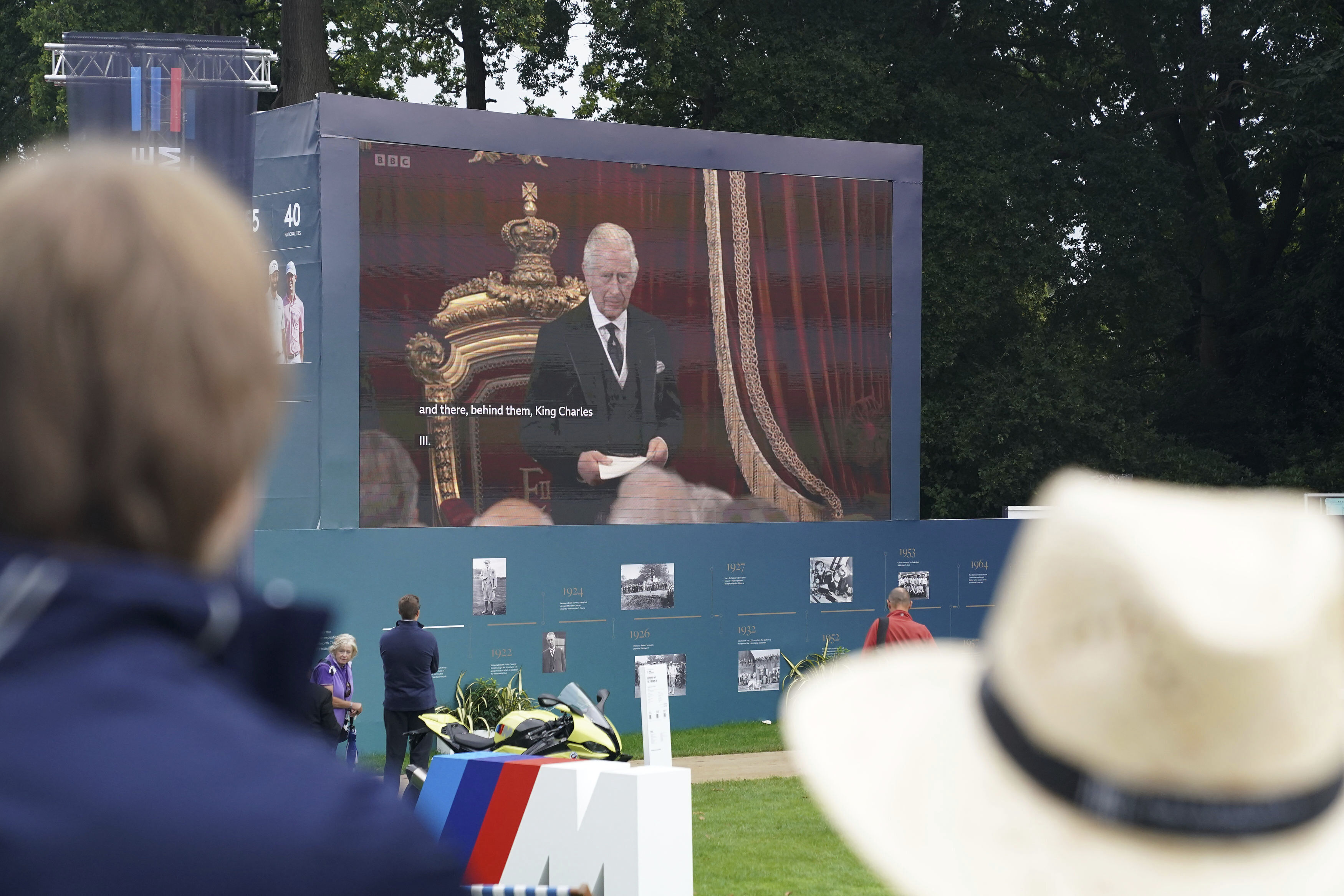 Spectators watch the Accession Council, where King Charles III is formally proclaimed monarch, on the big screen at Wentworth Golf Club, Virginia Water, Britain, Saturday, Sept. 10, 2022. 