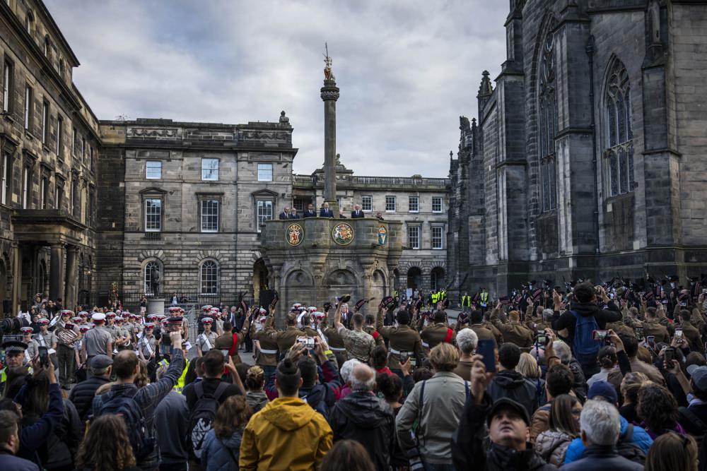 People watch the proclamation rehearsal outside St Giles' Cathedral, in Edinburgh, Scotland, Saturday. Queen Elizabeth II, Britain's longest-reigning monarch and a rock of stability across much of a turbulent century, died Thursday after 70 years on the throne. She was 96.