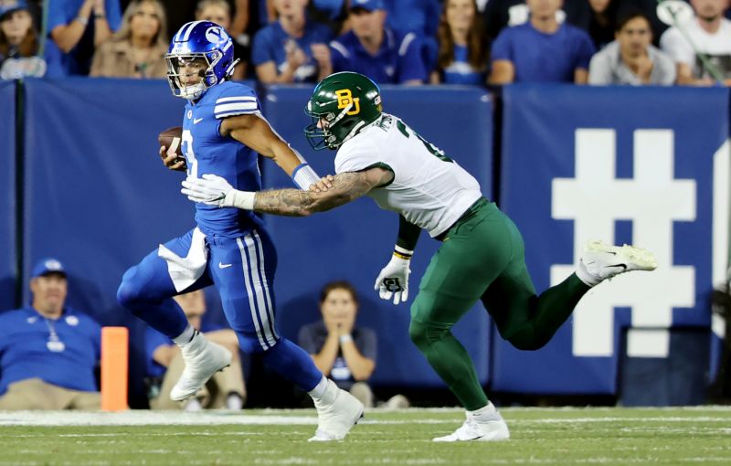 Brigham Young Cougars quarterback Jaren Hall (3) tries to run away from Baylor Bears linebacker Matt Jones (2) as BYU and Baylor play at LaVell Edwards Stadium in Provo on Saturday, Sept. 10, 2022. - Scott G Winterton, Deseret News