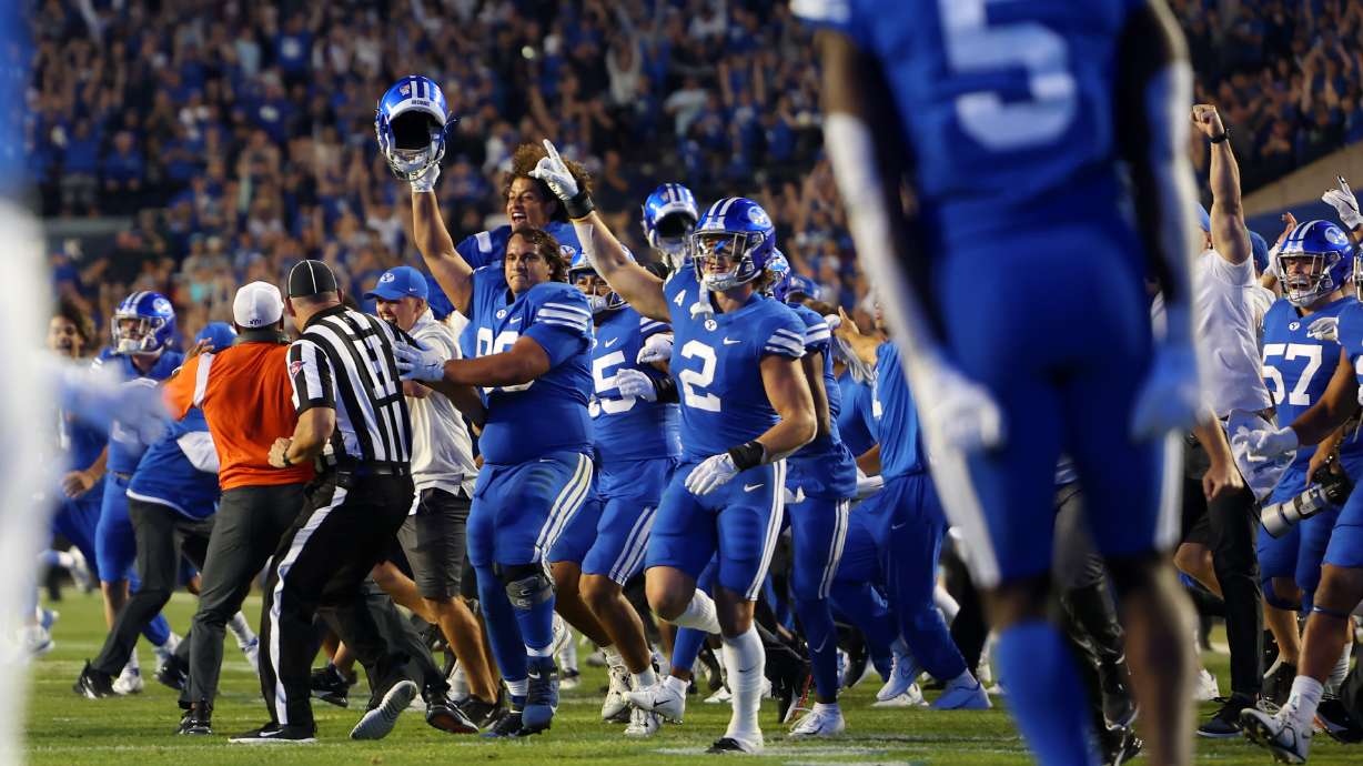 BYU rush the field after defeating Baylor in overtime 26-20 at LaVell Edwards Stadium in Provo on Sunday, Sept. 11, 2022.