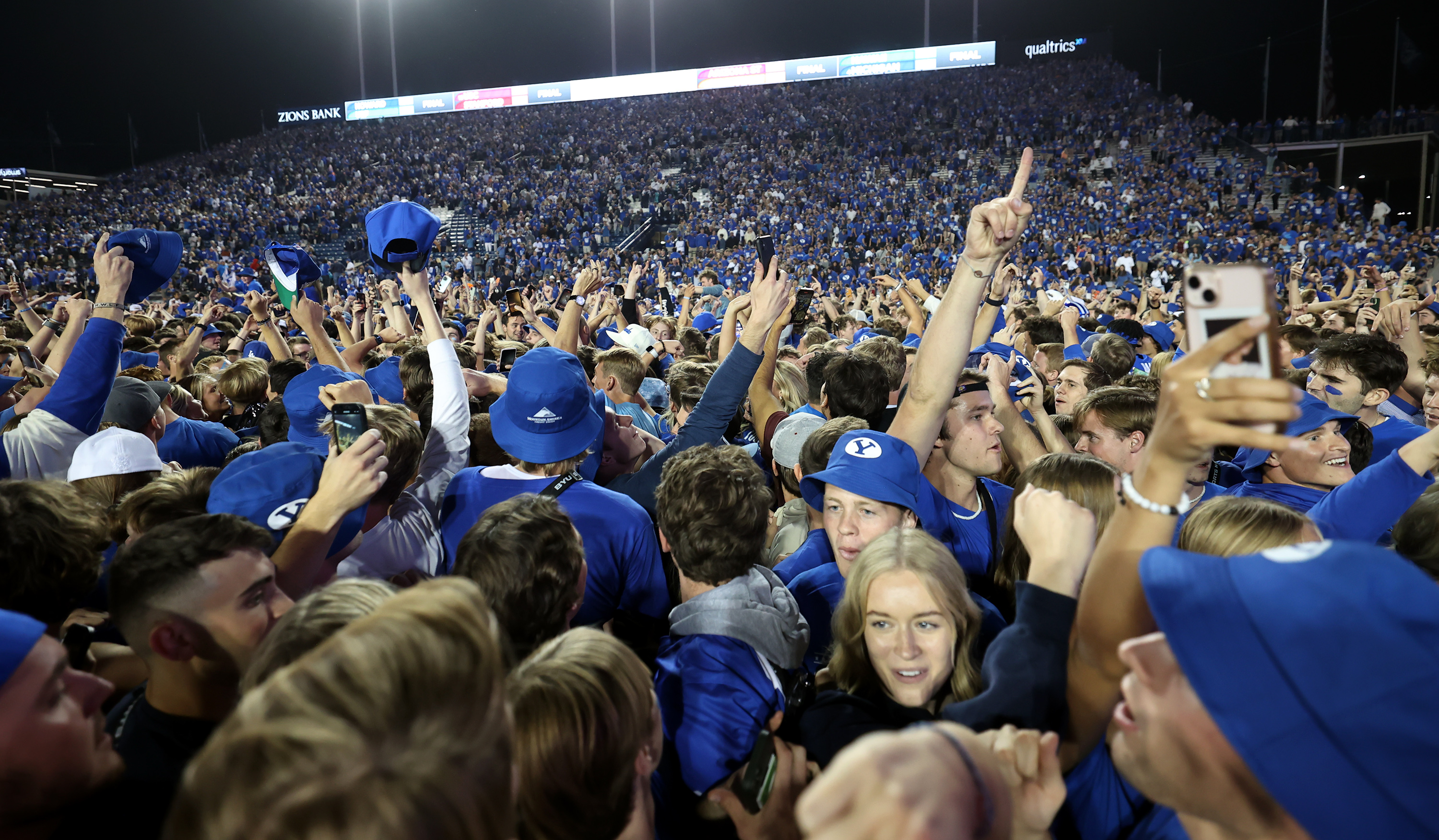BYU students and fans swarm the field after BYU defeated Baylor in overtime 26-20 at LaVell Edwards Stadium in Provo on Sunday, Sept. 11, 2022.