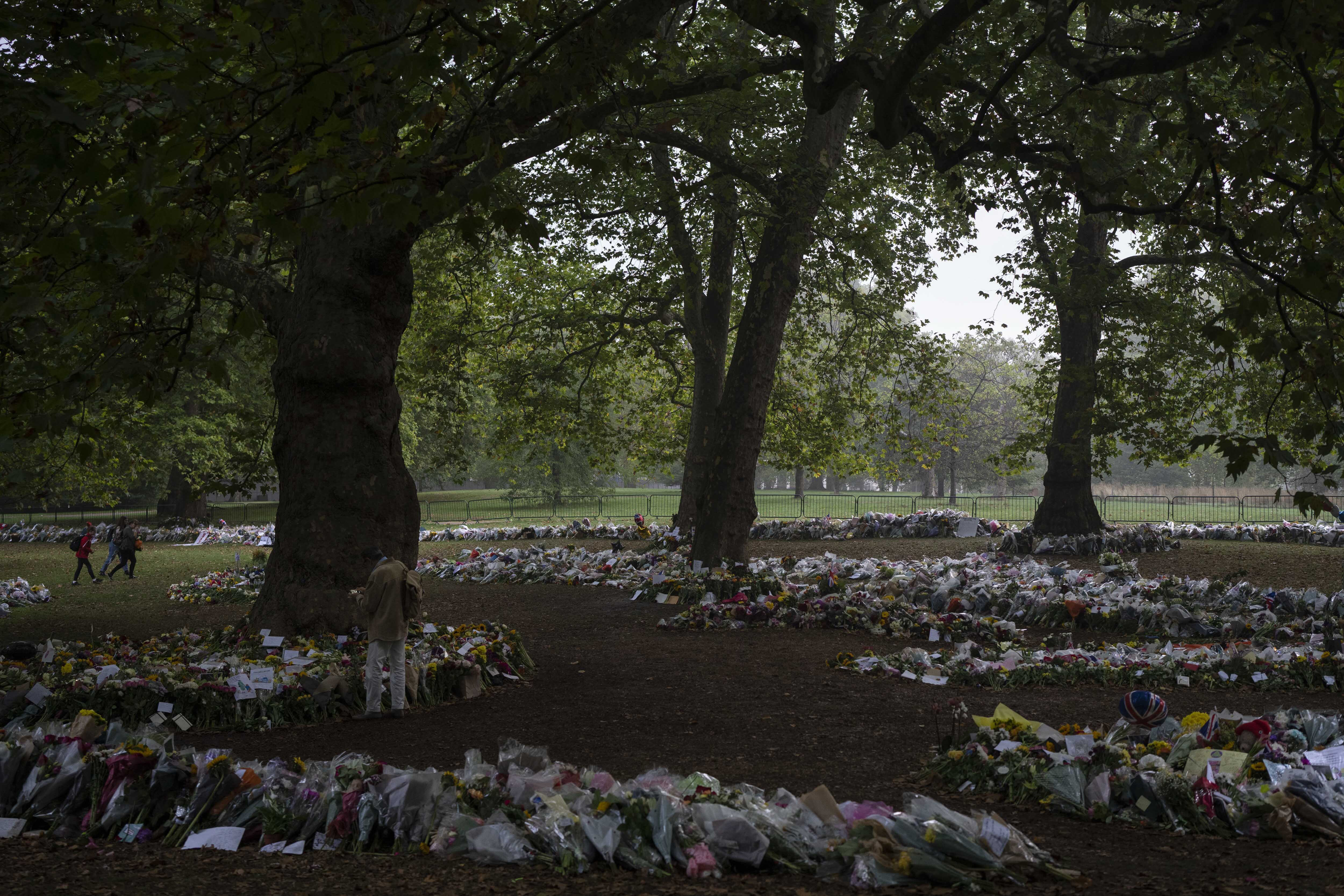 Mourners lay flowers for Queen Elizabeth II at Green Park, near Buckingham Palace in London, Sunday.