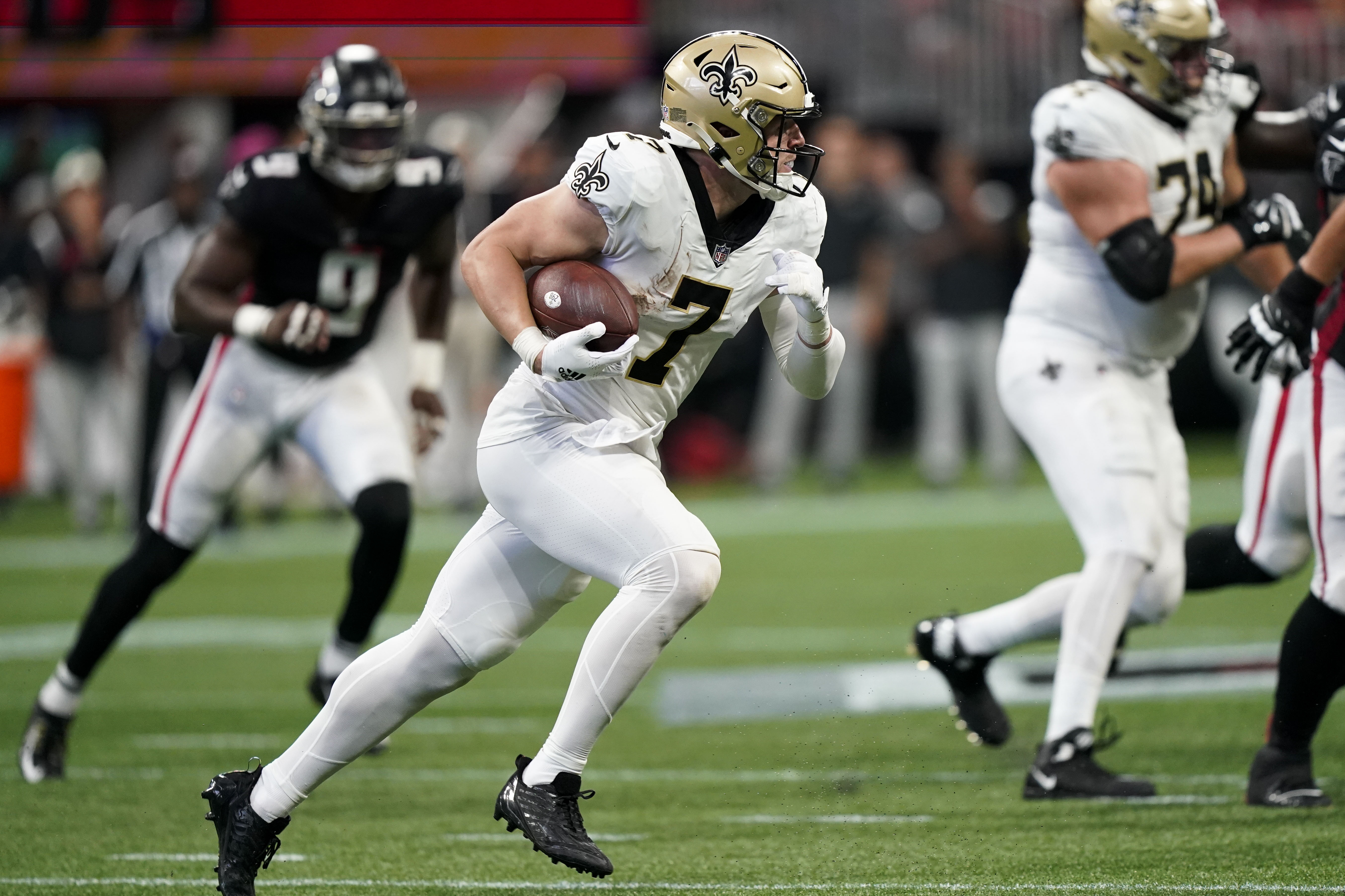 New Orleans Saints tight end Taysom Hill (7) runs after a ctach against the Atlanta Falcons during the second half of an NFL football game, Sunday, Sept. 11, 2022, in Atlanta.