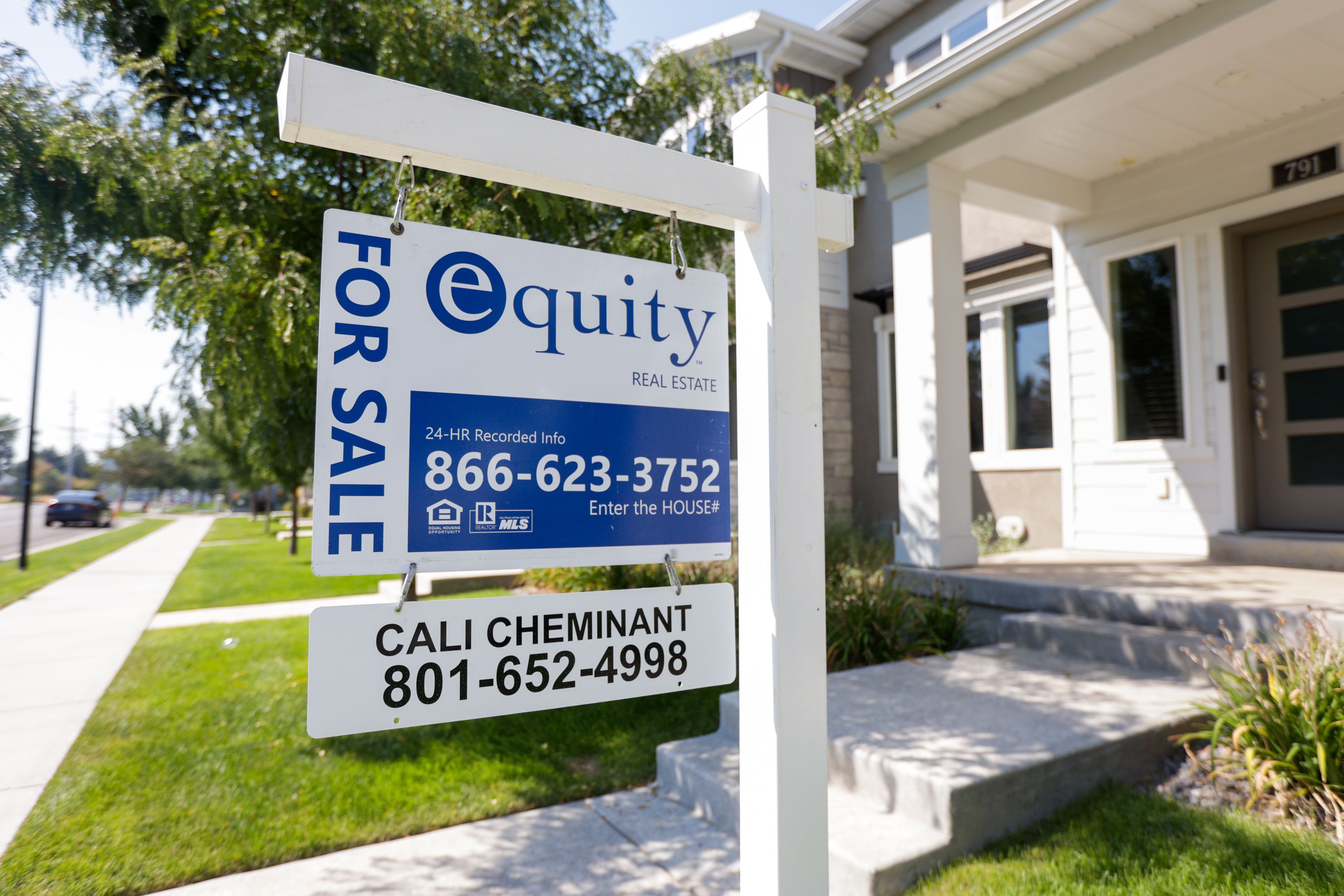 A “For Sale” sign stands in front of town houses in Sandy on Friday. As the Federal Reserve continues to wage its war on record high inflation rates, it appears higher interest rates are likely here to stay for at least the next year or even longer — which means the U.S. housing market slump isn't going anywhere anytime soon. 