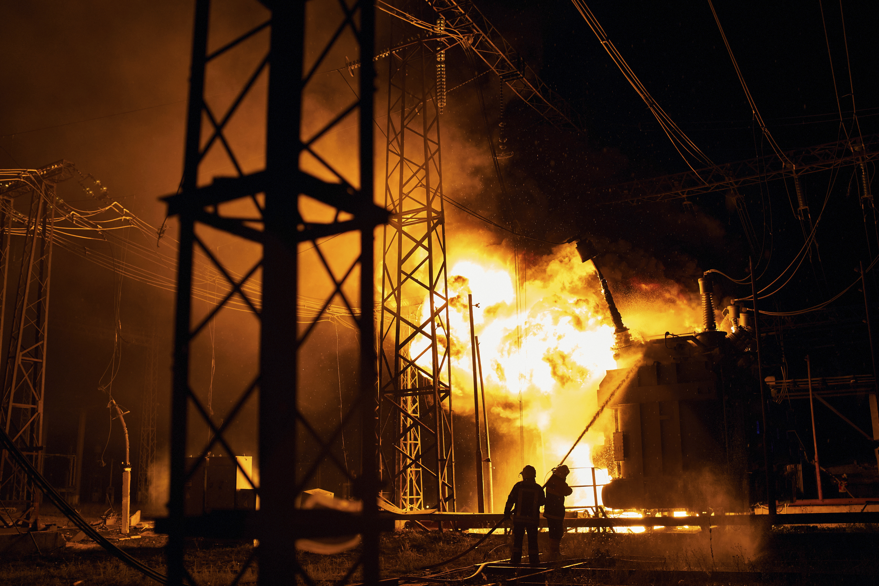 Ukrainian State Emergency Service firefighters put out the fire after a Russian rocket attack hit an electric power station in Kharkiv, Ukraine, Sunday. The Kharkiv and Donetsk regions have been completely de-energized in the rocket attack.