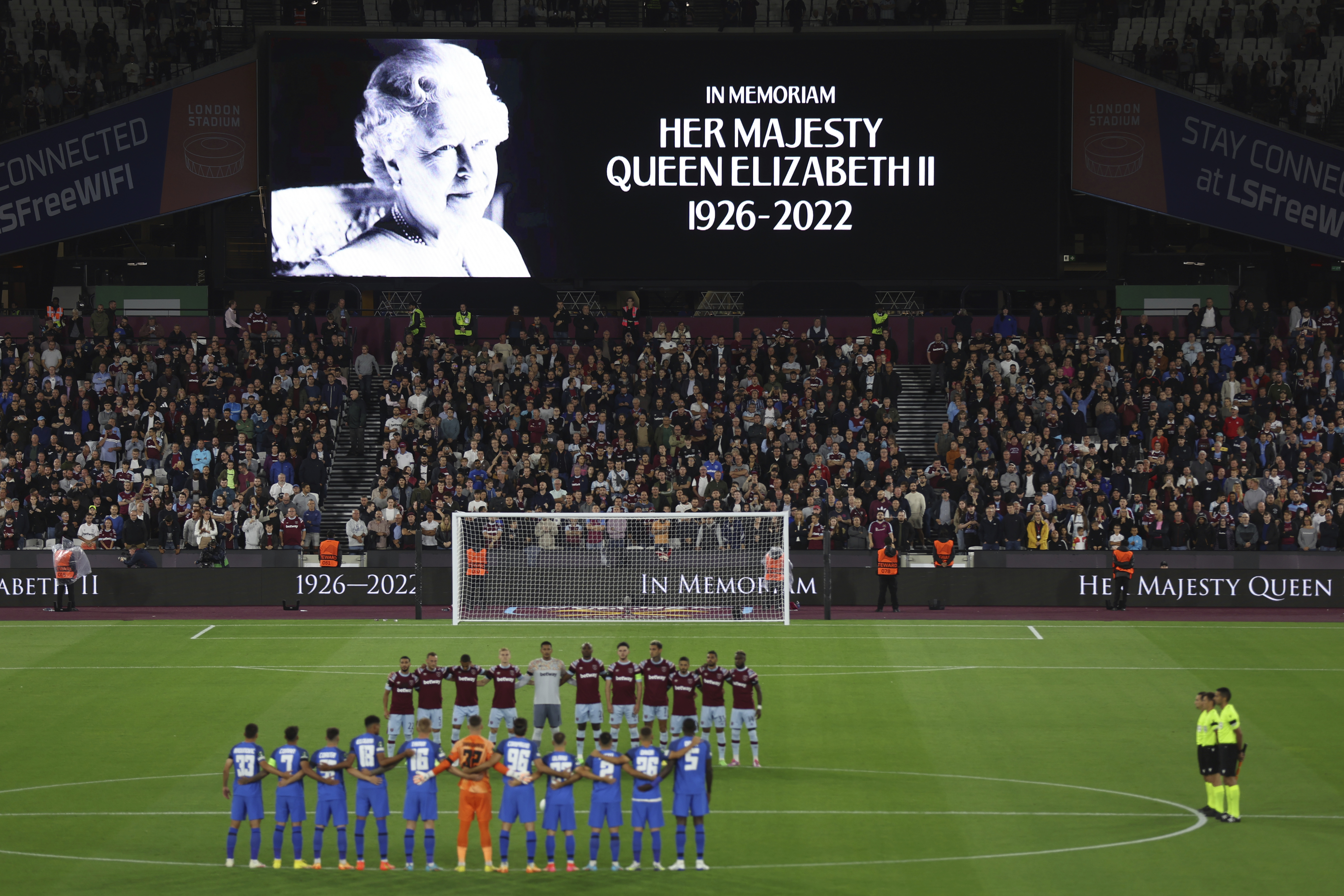 Team players stand on the pitch during minutes silence following the death of Queen Elizabeth II prior the Group B Europa Conference League soccer match between West Ham and FCSB Steaua Bucharest at London Stadium in London, Thursday, Sept. 8, 2022. 