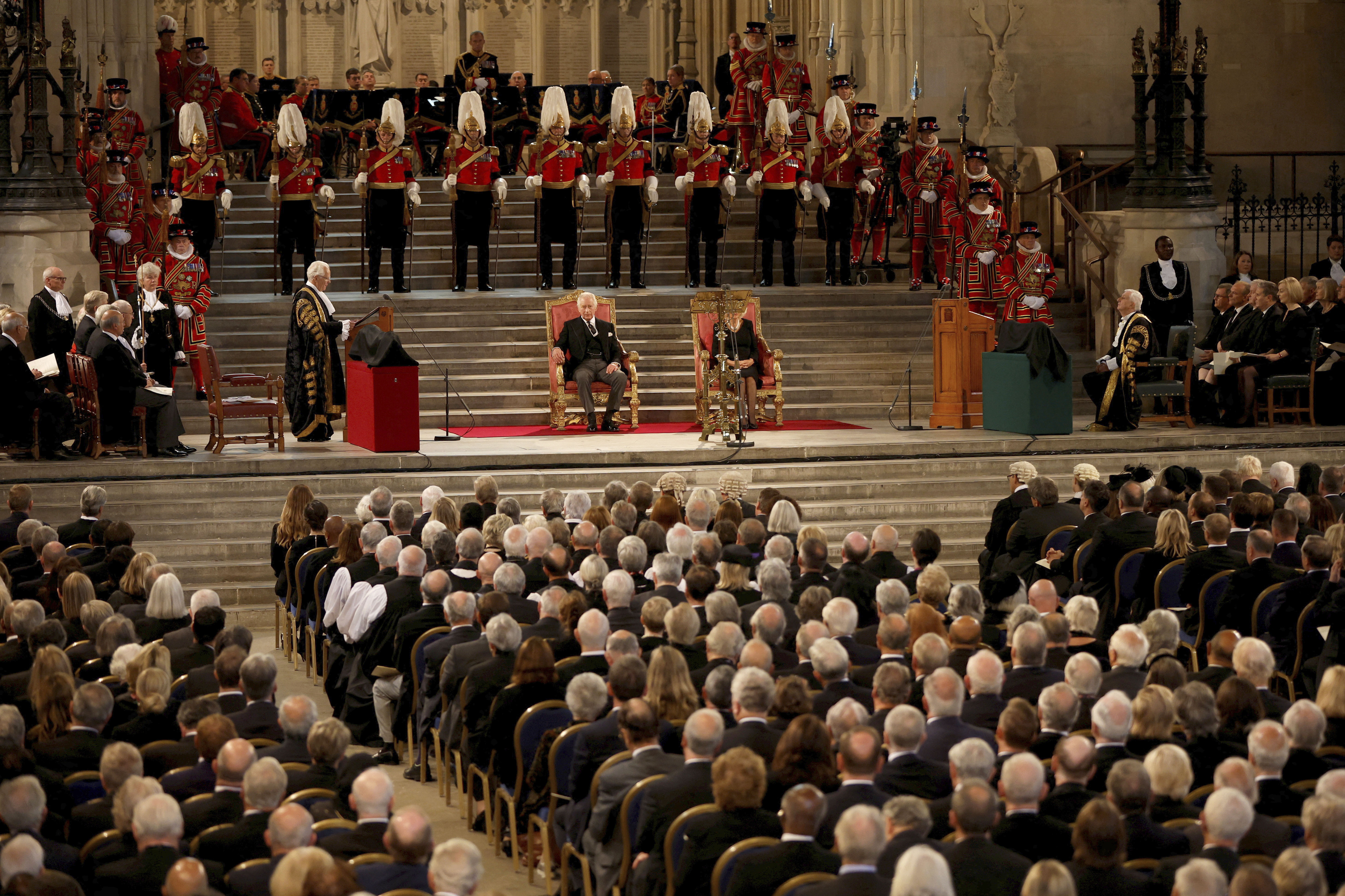 Members of Parliament attend a visit by Britain's King Charles III and Camilla, the Queen Consort, center, at Westminster Hall, where both Houses of Parliament are meeting to express their condolences following the death of Queen Elizabeth II, at Westminster Hall, in London, Monday.