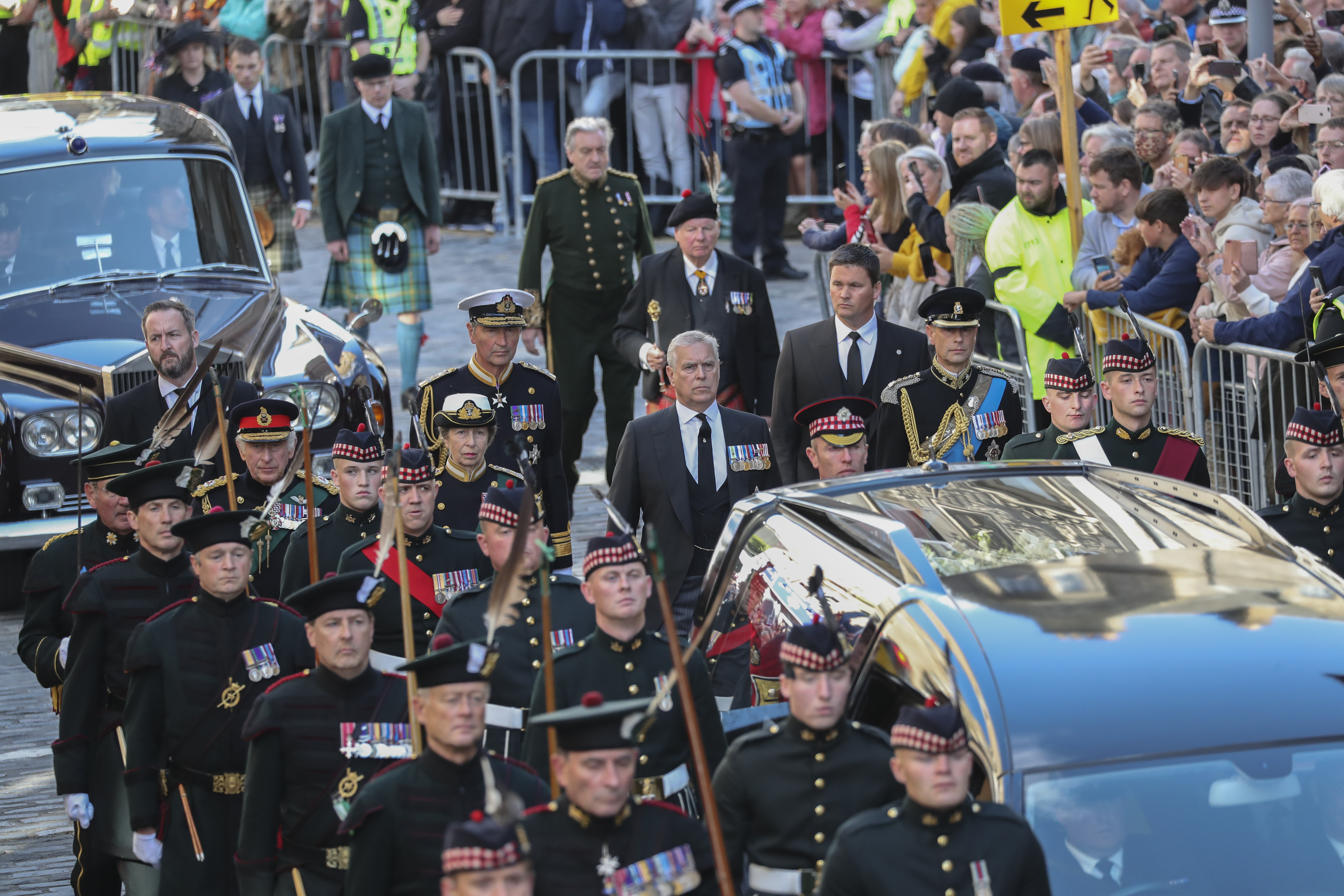 The procession with the coffin of Queen Elizabeth II, followed by, from left, King Charles III, Princess Anne, Prince Andrew, and Prince Edward, heads up the Royal Mile to St Giles' Cathedral in Edinburgh, Monday.