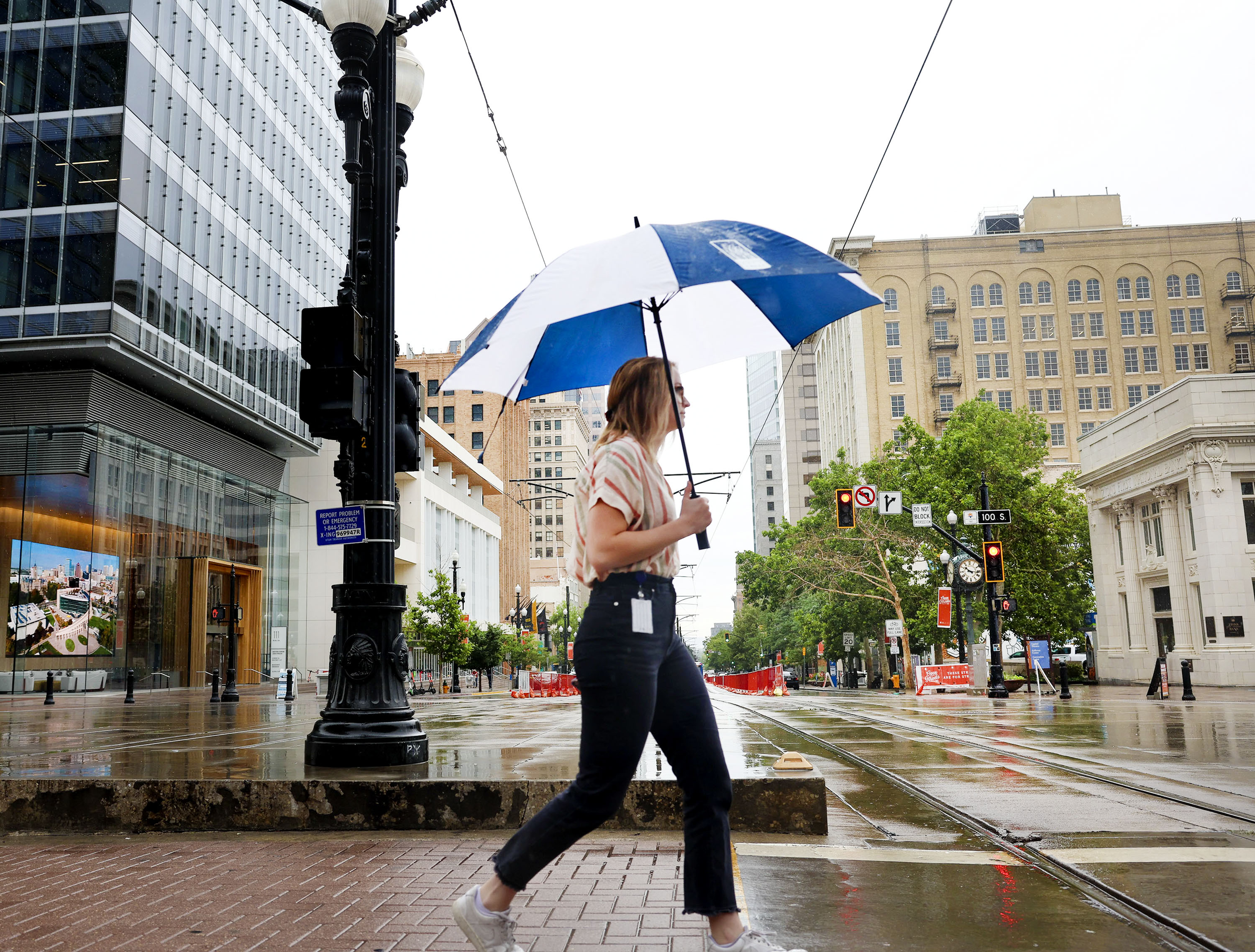 Ina Kivijärvi walks in the rain in downtown Salt Lake City on July 15. Rain is expected to return to Utah this week as a result of a few storm systems passing through the state.