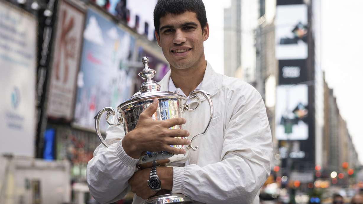 U.S. Open men's singles tennis champion Carlos Alcaraz poses in Times Square, Monday, Sept. 12, 2022, in New York.