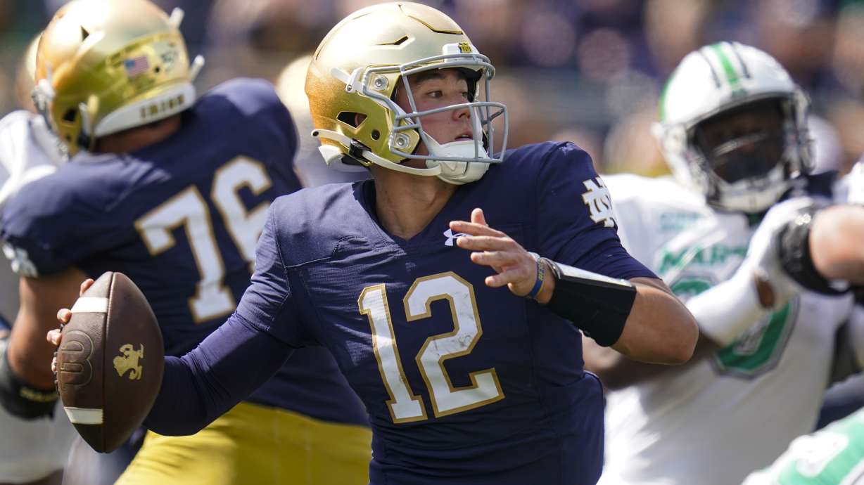 Notre Dame quarterback Tyler Buchner (12) throws against Marshall during the first half of an NCAA college football game in South Bend, Ind., Saturday, Sept. 10, 2022.