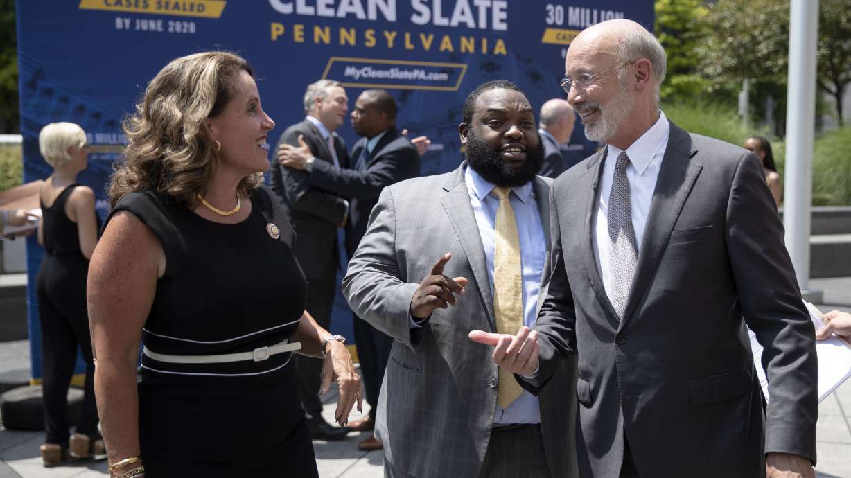 Pennsylvania Gov. Tom Wolf, right, walks with Rep. Sheryl Delozier, R-Cumberland, left, and Rep. Jordan Harris D-Philadelphia, during a news conference in Harrisburg, Pa., June 28, 2019. Lower level criminal convictions are starting to be automatically sealed under a year-old Pennsylvania state law touted as a way to give offenders a fresh start.