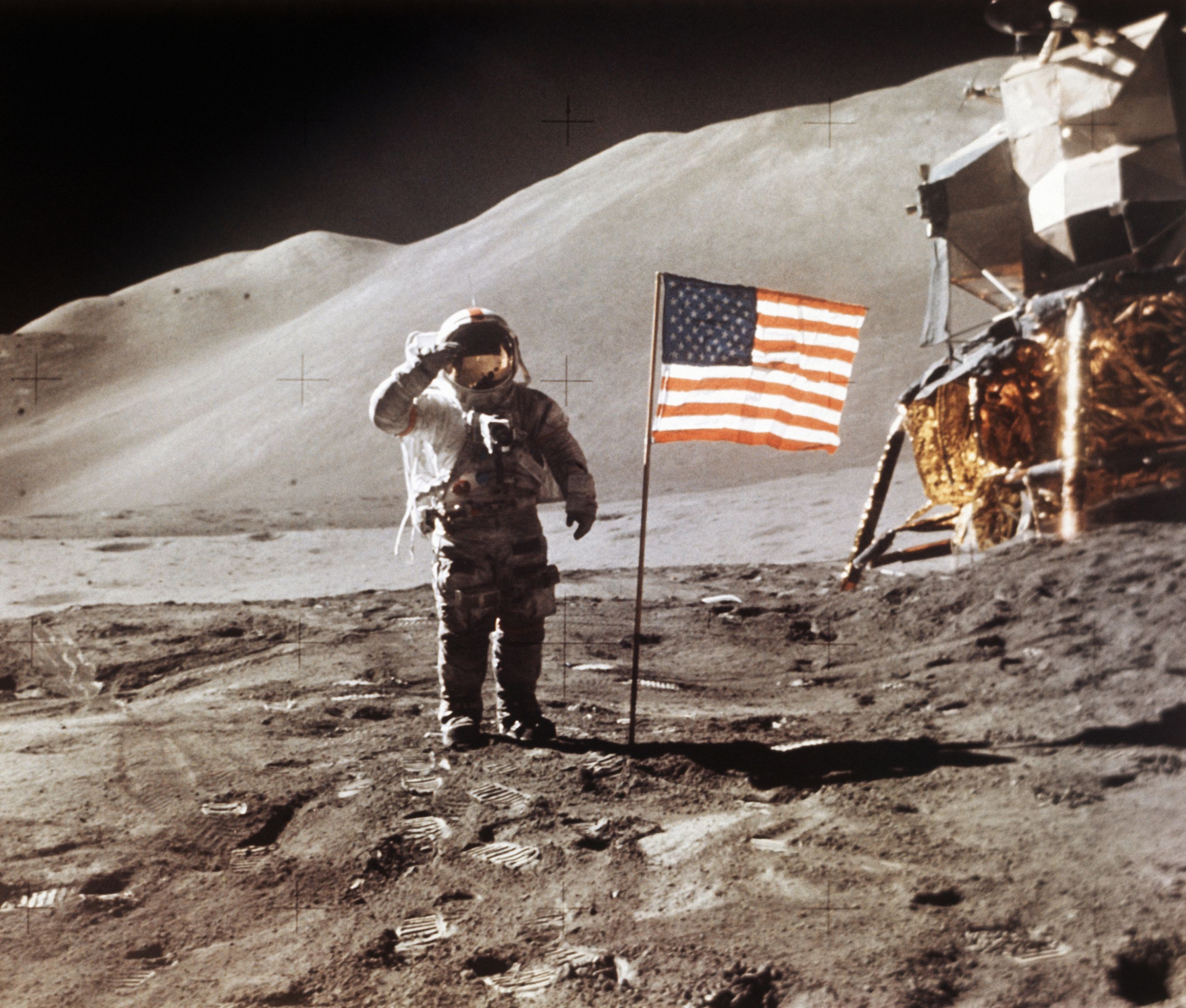 In this July 30, 1971, photo made available by NASA, Apollo 15 Lunar Module Pilot James B. Irwin salutes while standing beside the fourth American flag planted on the surface of the moon.