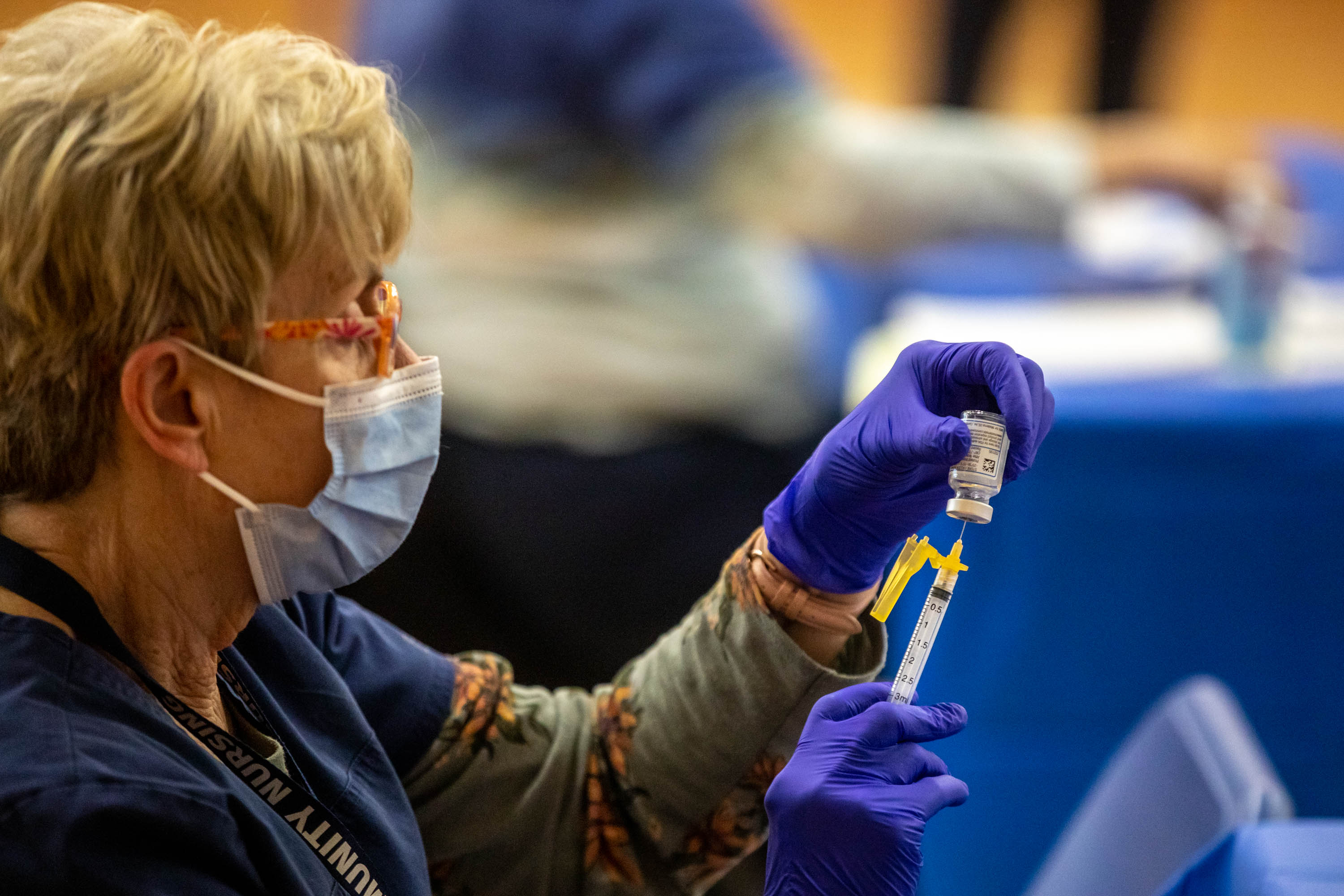 Marilyn Gertsch prepares a COVID-19 vaccine at the Canyons School District's final vaccination clinic at Mount Jordan Middle School in Sandy on March 11, 2021. The World Health Organization announced COVID-19 is no longer considered an emergency on Friday.