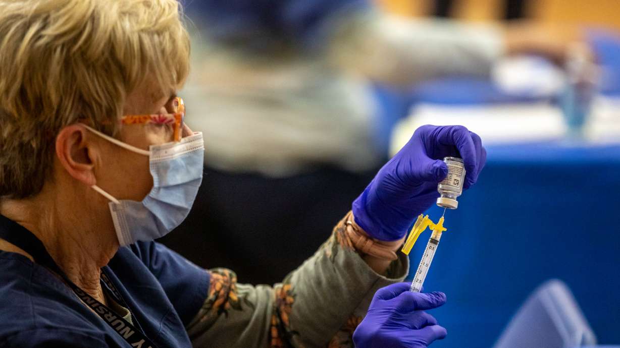 Marilyn Gertsch prepares a COVID-19 vaccine at the Canyons School District's final vaccination clinic at Mount Jordan Middle School in Sandy on March 11, 2021. Utah health officials reported 2,487 new COVID-19 cases over the past week and 12 additional deaths. They also announced the state surpassed 5,000 deaths as of Thursday.