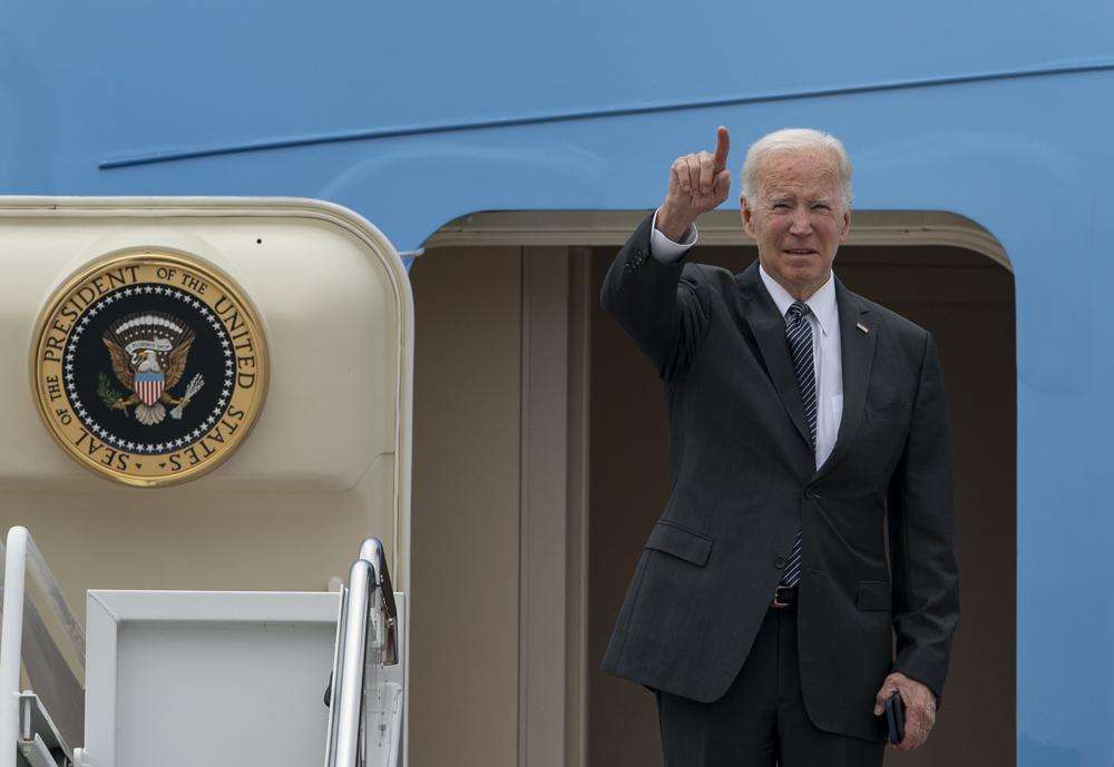 President Joe Biden gestures as he boards Air Force One Monday at Andrews Air Force Base, Md. Biden on Monday urged Americans to come together for a new "national purpose" — his administration's effort to end cancer "as we know it."