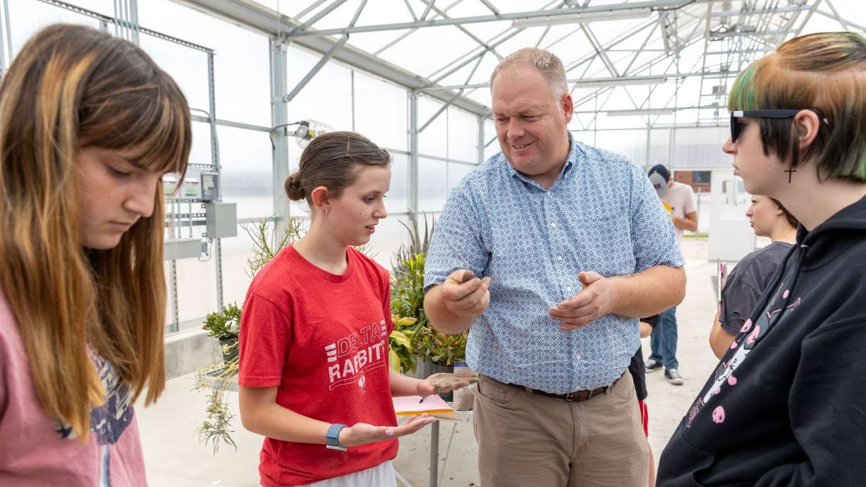 Chad Warnick, middle, demonstrates how to analyze dirt to Lyndie Pederen, 16, during a lab inside the greenhouse at Delta Technical Center, a technical high school in Delta on Monday. Warnick won 2023 Utah Teacher of the Year and has been teaching in the Delta school system for 17 years.