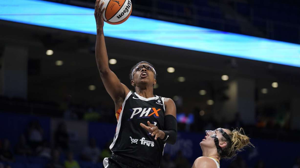 FILE - Phoenix Mercury guard Diamond DeShields shoots next to Dallas Wings guard Marina Mabrey during the second half of a WNBA basketball game, June 17, 2022, in Arlington, Texas. DeShields will be chronicling her journey with USA Basketball as they prep for and play in the FIBA World Cup in Australia.