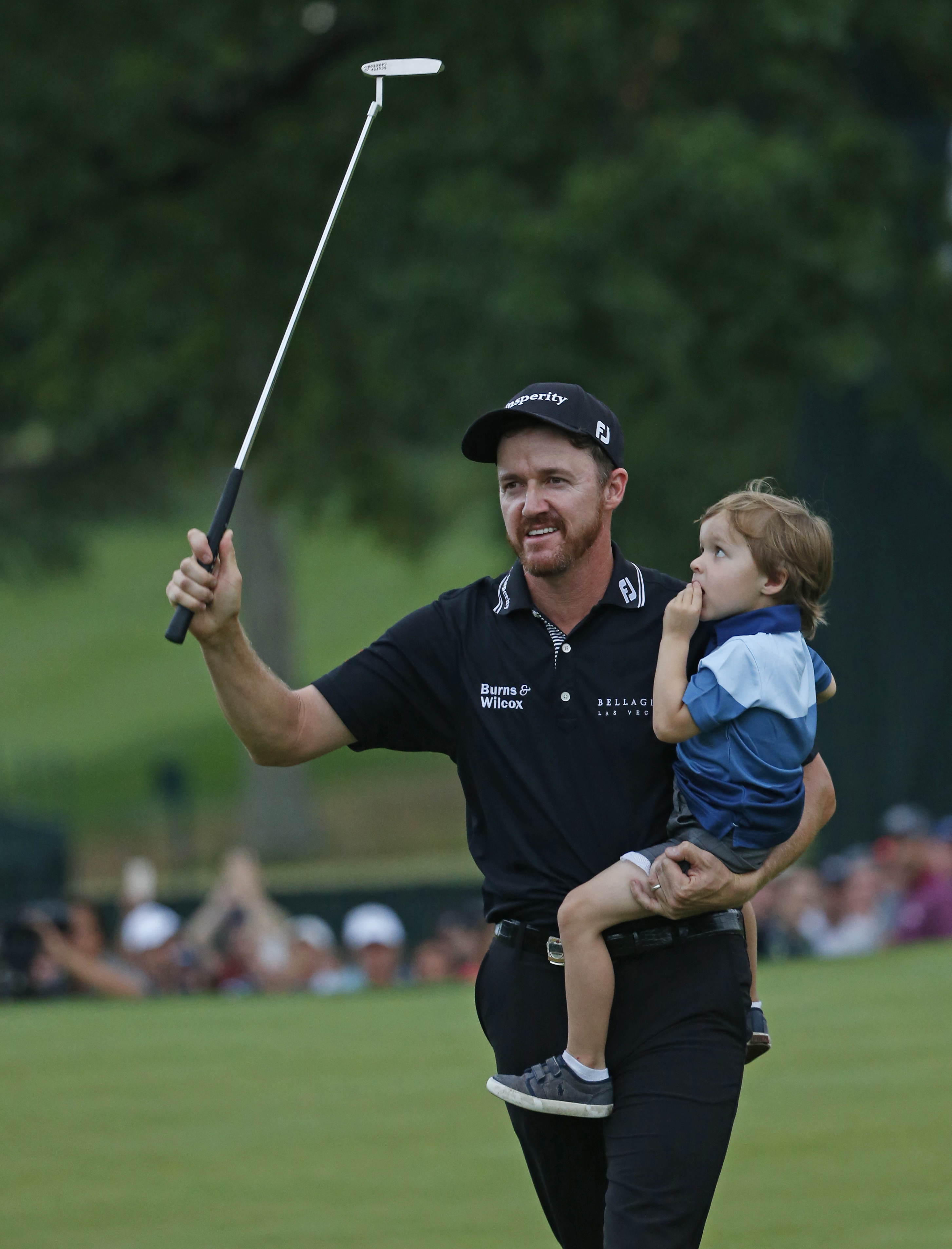 FILE - Jimmy Walker celebrates with his son Beckett after winning the PGA Championship golf tournament at Baltusrol Golf Club in Springfield, N.J., on July 31, 2016. Walker earned a full PGA Tour card for the season that starts Thursday, Sept. 15, 2022, because of all the LIV Golf defections. Walker had walked away from golf in April.