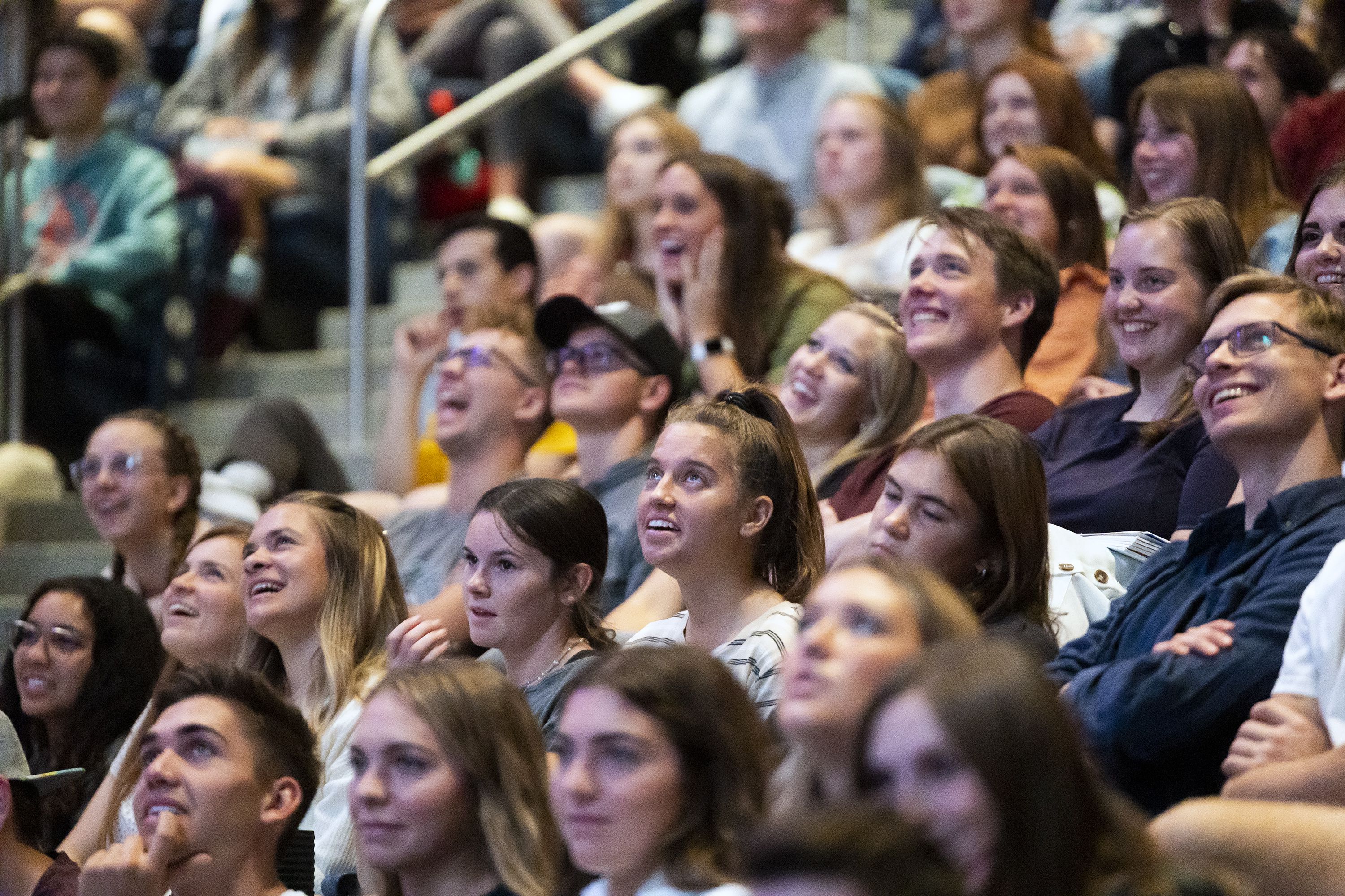 Audience members laugh as they watch a humorous video presented as President Dallin H. Oaks during his campus devotional address at Brigham Young University’s Marriott Center in Provo on Tuesday.
