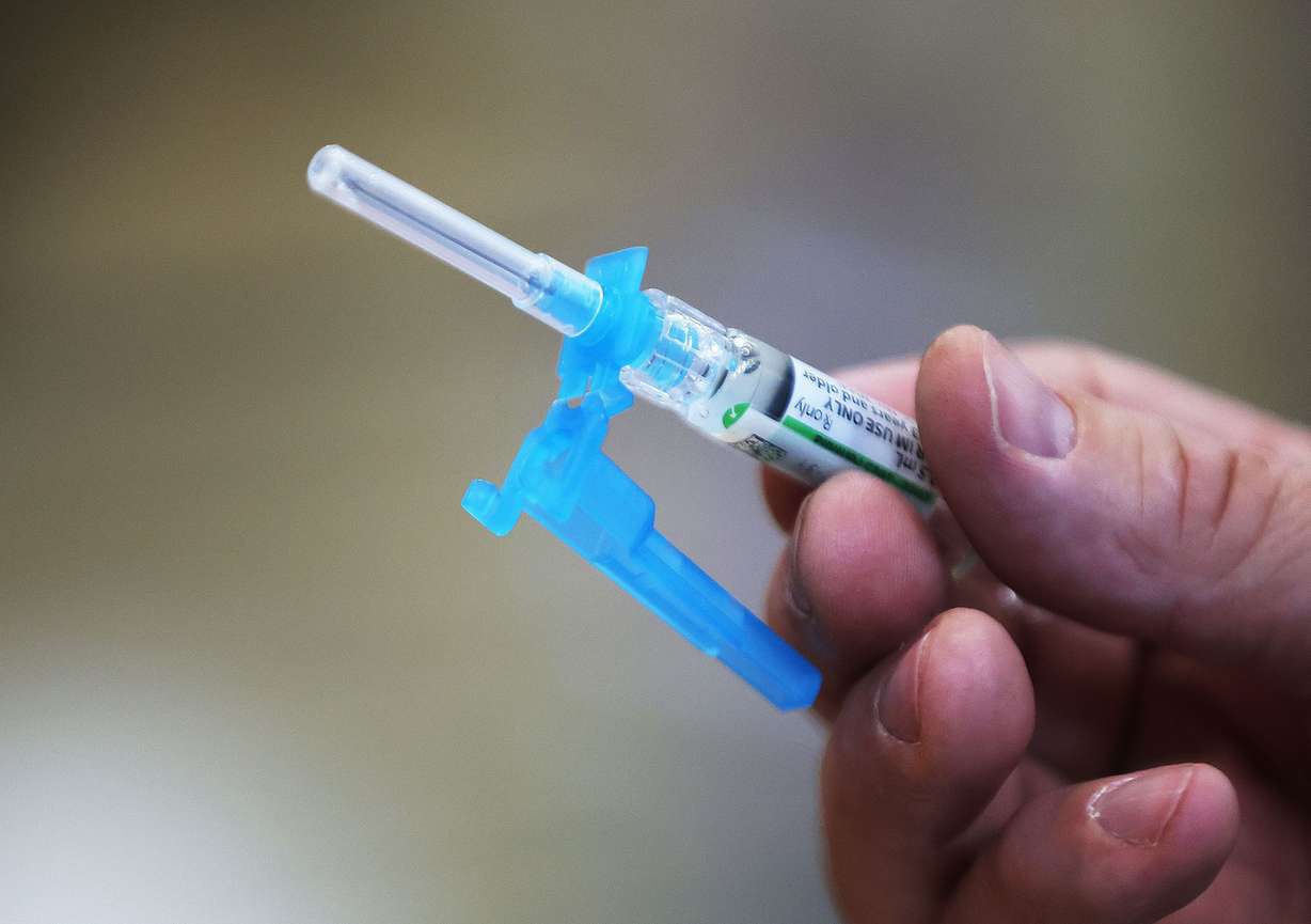 A flu shot is prepared at Jolley’s Pharmacy in West Jordan on Tuesday. Flu shots aren't something most people think about until later in the fall or even winter.But that's changing this year now that everyone is being urged to get the newly updated COVID-19 booster shots as soon as they're eligible.