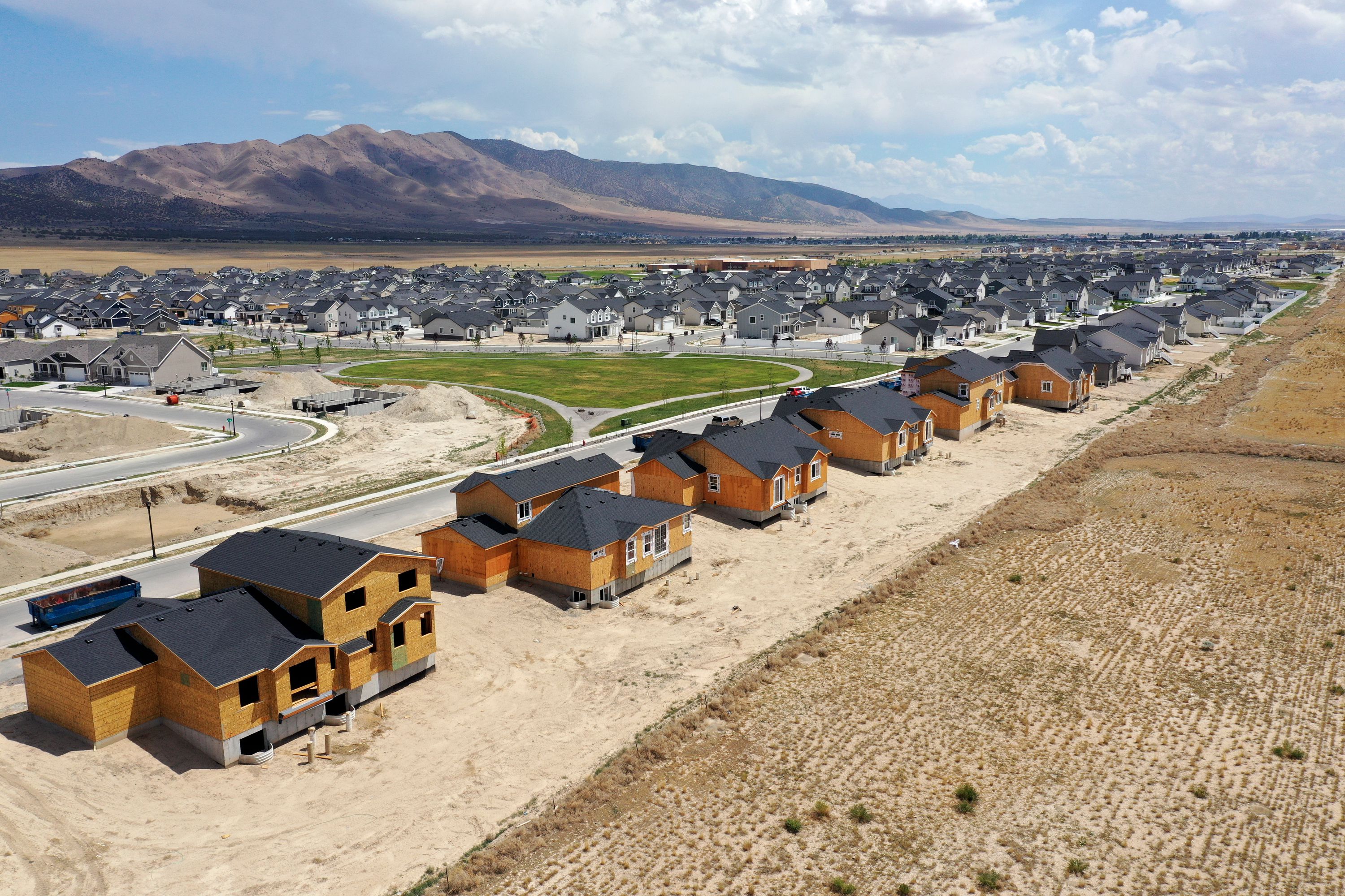 Single-family homes under construction in the Overland community in Eagle Mountain are pictured on July 19. As the high interest rate-induced U.S. housing slump deepens, national housing experts and economists are watching home prices dip across the country — with some regional pockets dropping much faster than others. 