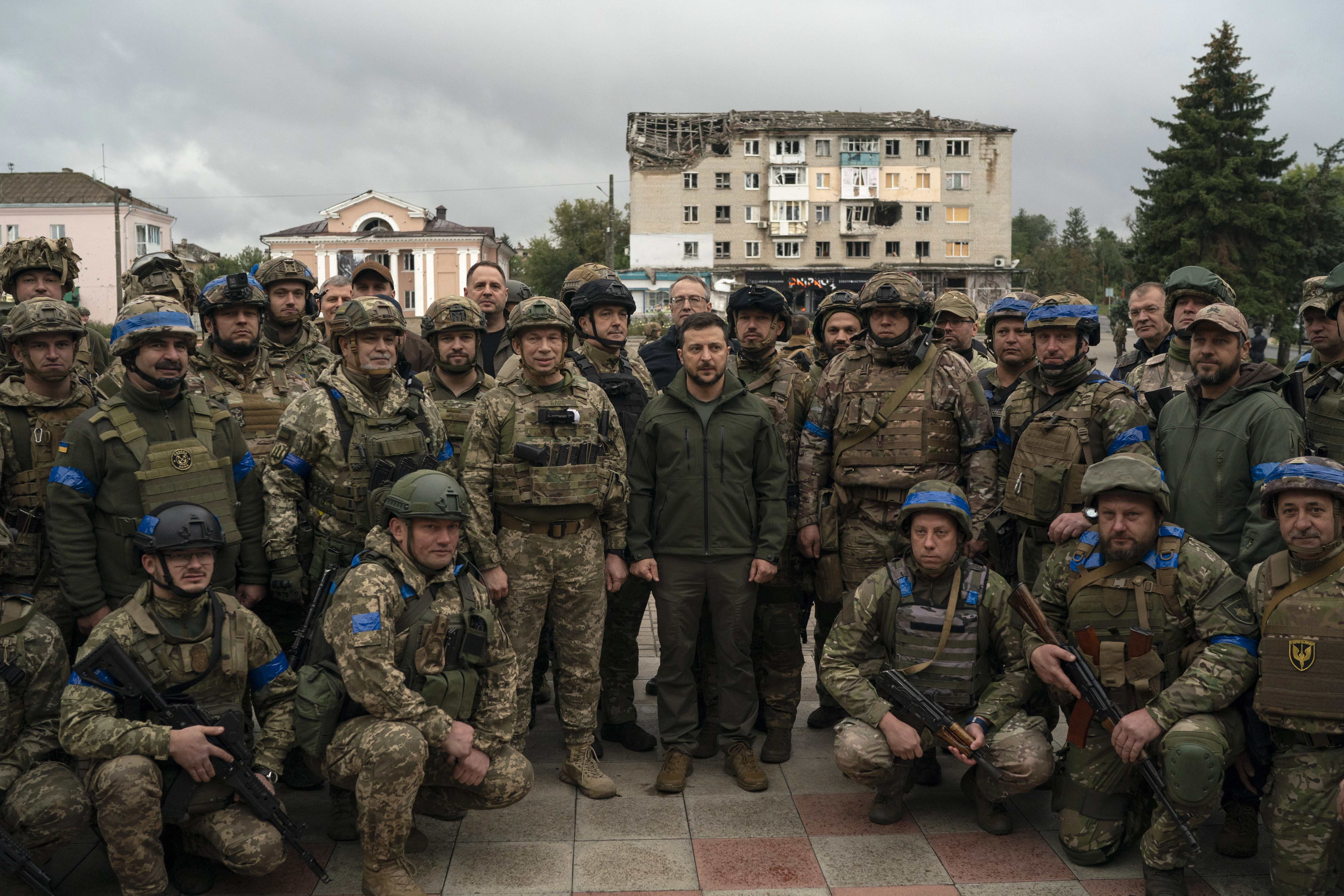 Ukrainian President Volodymyr Zelenskyy poses for a photo with soldiers after attending a national flag-raising ceremony in the freed Izium, Ukraine, Wednesday. Zelenskyy visited the recently liberated city on Wednesday, greeting soldiers and thanking them for their efforts in retaking the area, as the Ukrainian flag was raised in front of the burned-out city hall building.