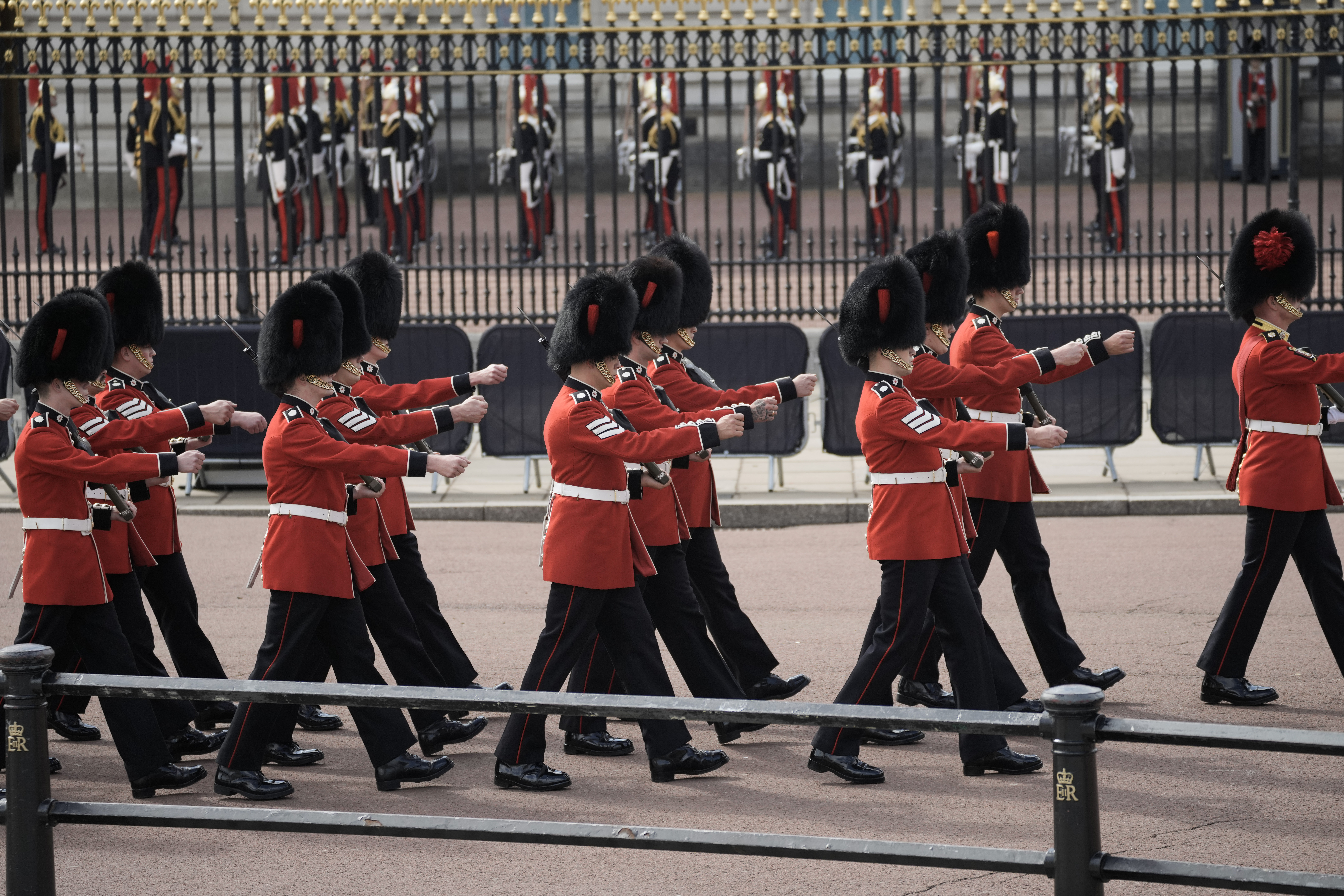 Grenadier Guards arrive at Buckingham Palace from where the coffin of late Queen Elizabeth II will depart in procession to Westminster Hall in London, Wednesday. The Queen will lie in state in Westminster Hall for four full days before her funeral on Monday.