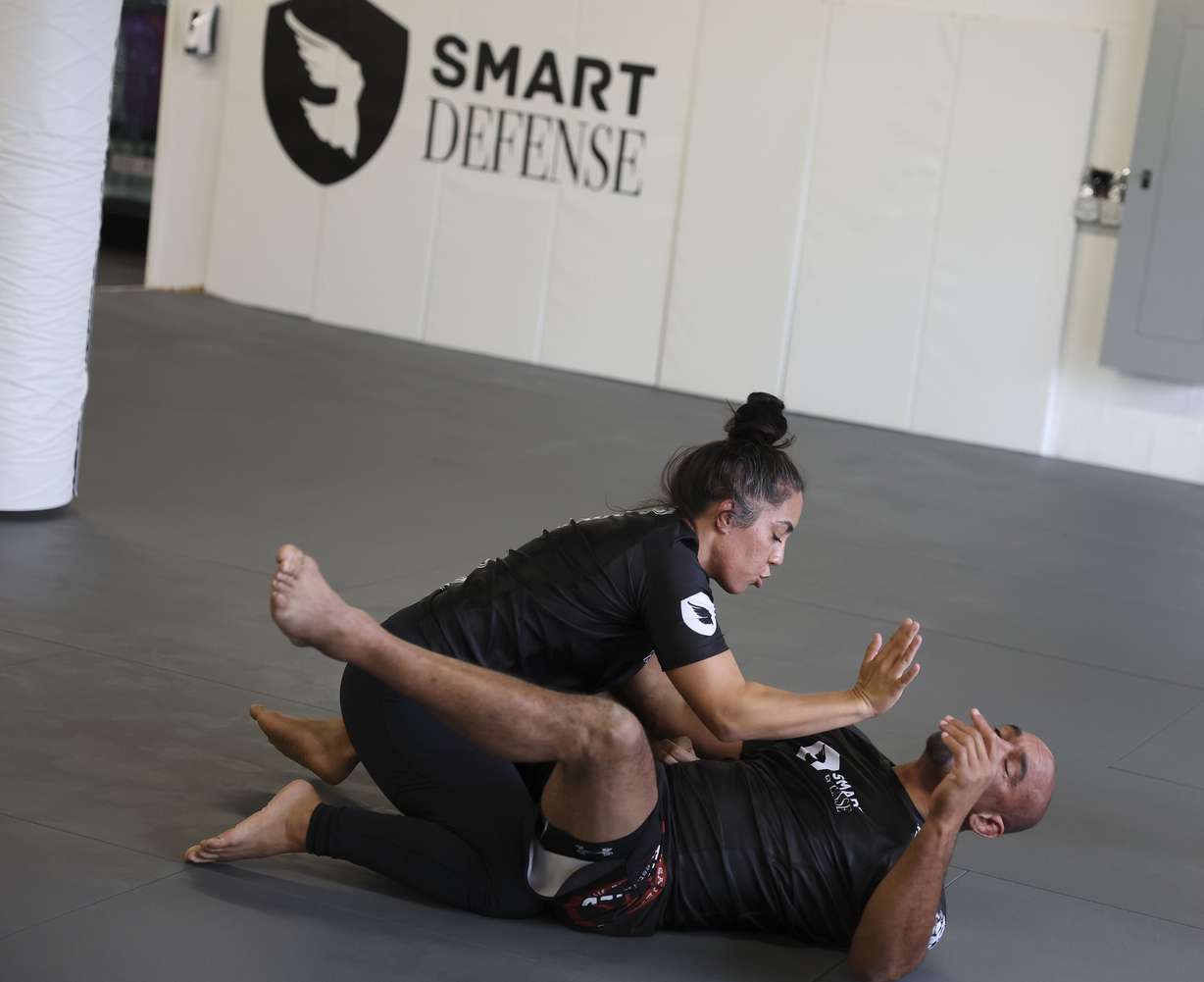 Steph Oguey and Carl Sims demonstrate a self-defense tactic at the Elizabeth Smart Foundation office in Salt Lake City on Wednesday. The foundation and Southern Utah University have teamed up to offer Smart Defense classes to SUU students beginning this fall.
