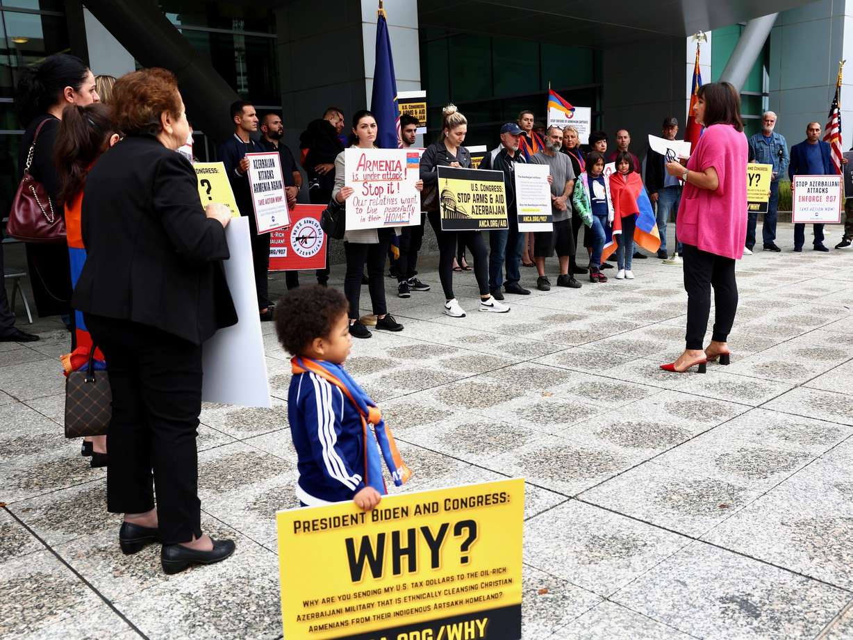 Utah Chair of the Armenian Assembly of America Narine Sarkissian, in pink, talks to a group of protesters outside the Wallace F. Bennett Federal Building in Salt Lake City on Wednesday.