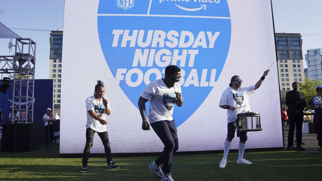FILE - Robert "Bojo" Ackah, center, and Fik-Shun, left, perform during the announcement of the first Thursday Night Football on Prime Video matchup featuring the San Diego Chargers at Kansas City Chiefs at the 2022 NFL Draft on Thursday, April 28, 2022 in Las Vegas. The Thursday night, Sept. 15 game between the Los Angeles Chargers and Kansas City Chiefs kicks off Amazon Prime Video's 11-year agreement with the NFL to carry “Thursday Night Football".